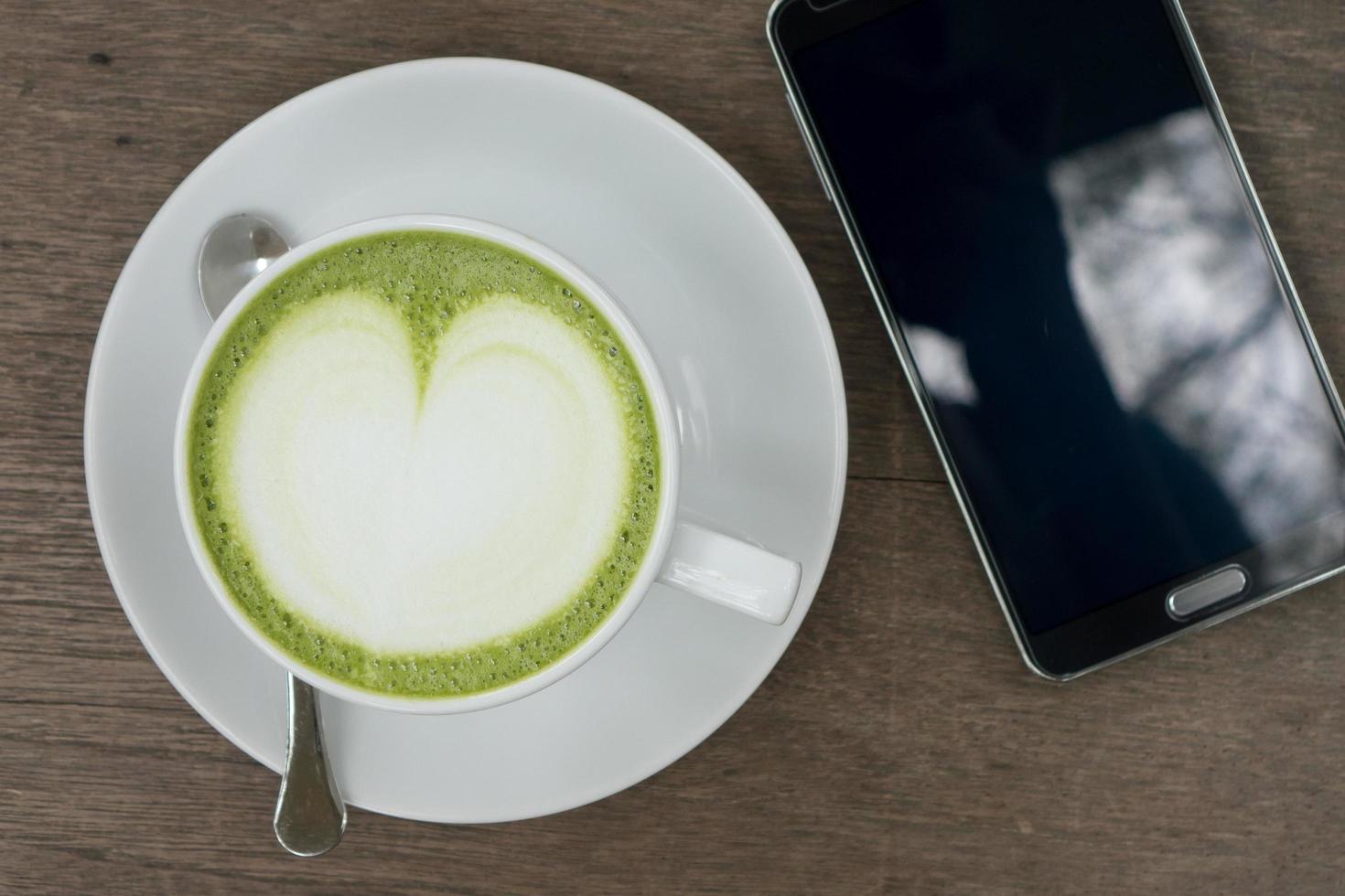 Green tea latte on wood background photo