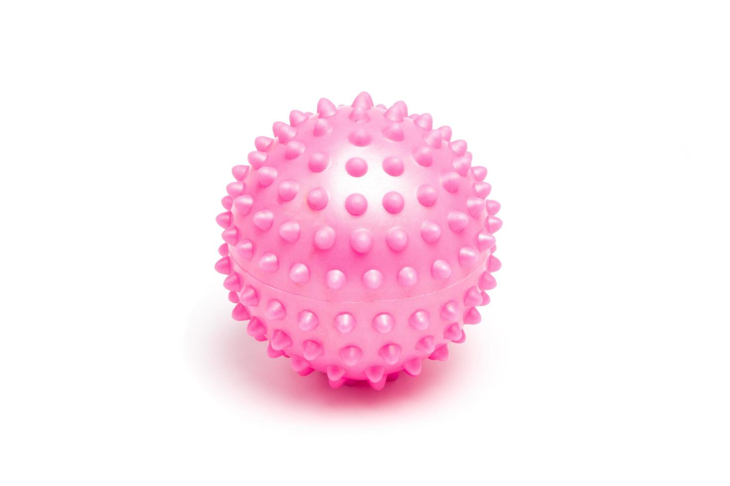 Pink spiky massage ball on white background photo