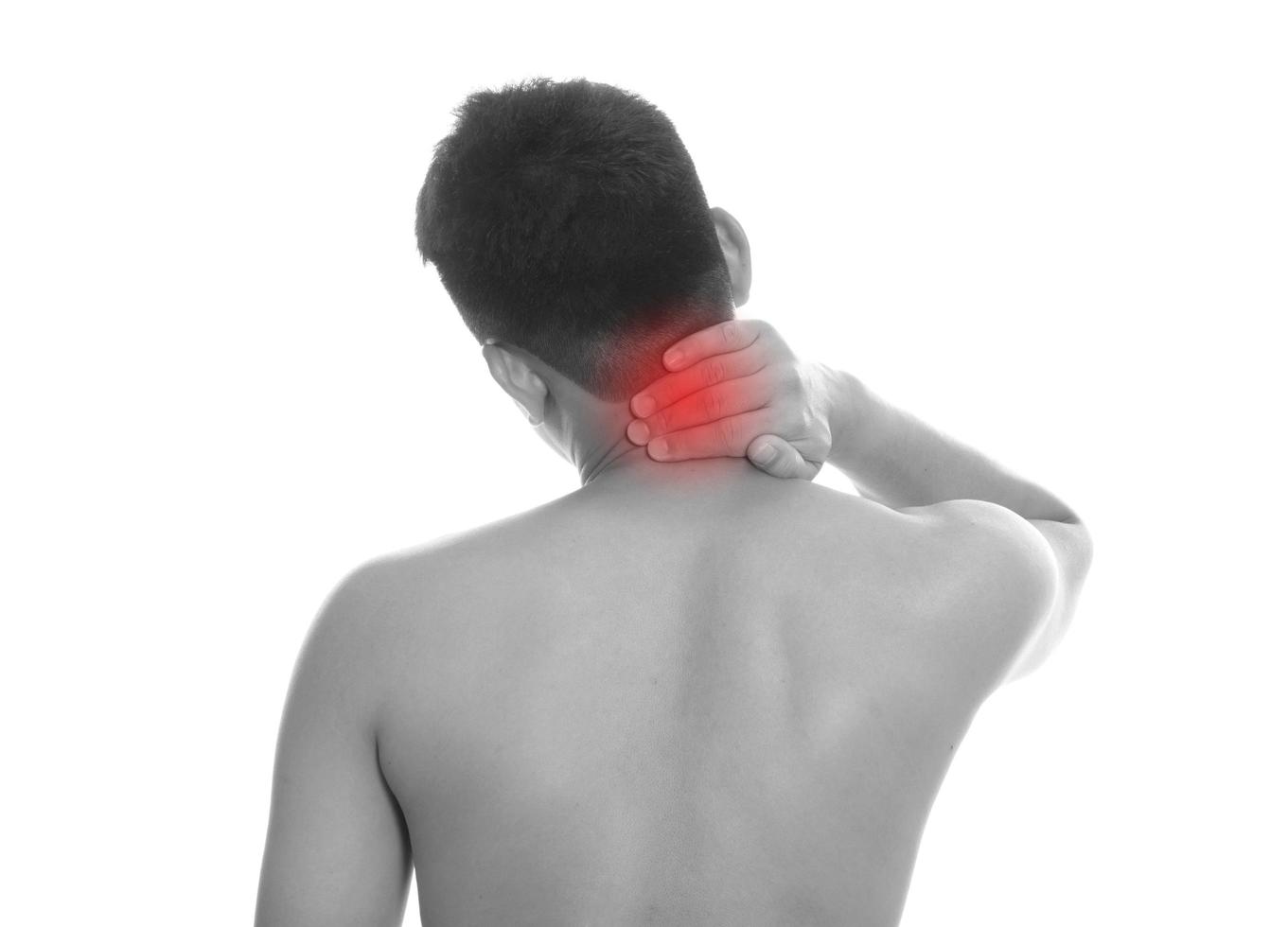 Man with neck pain over white background photo