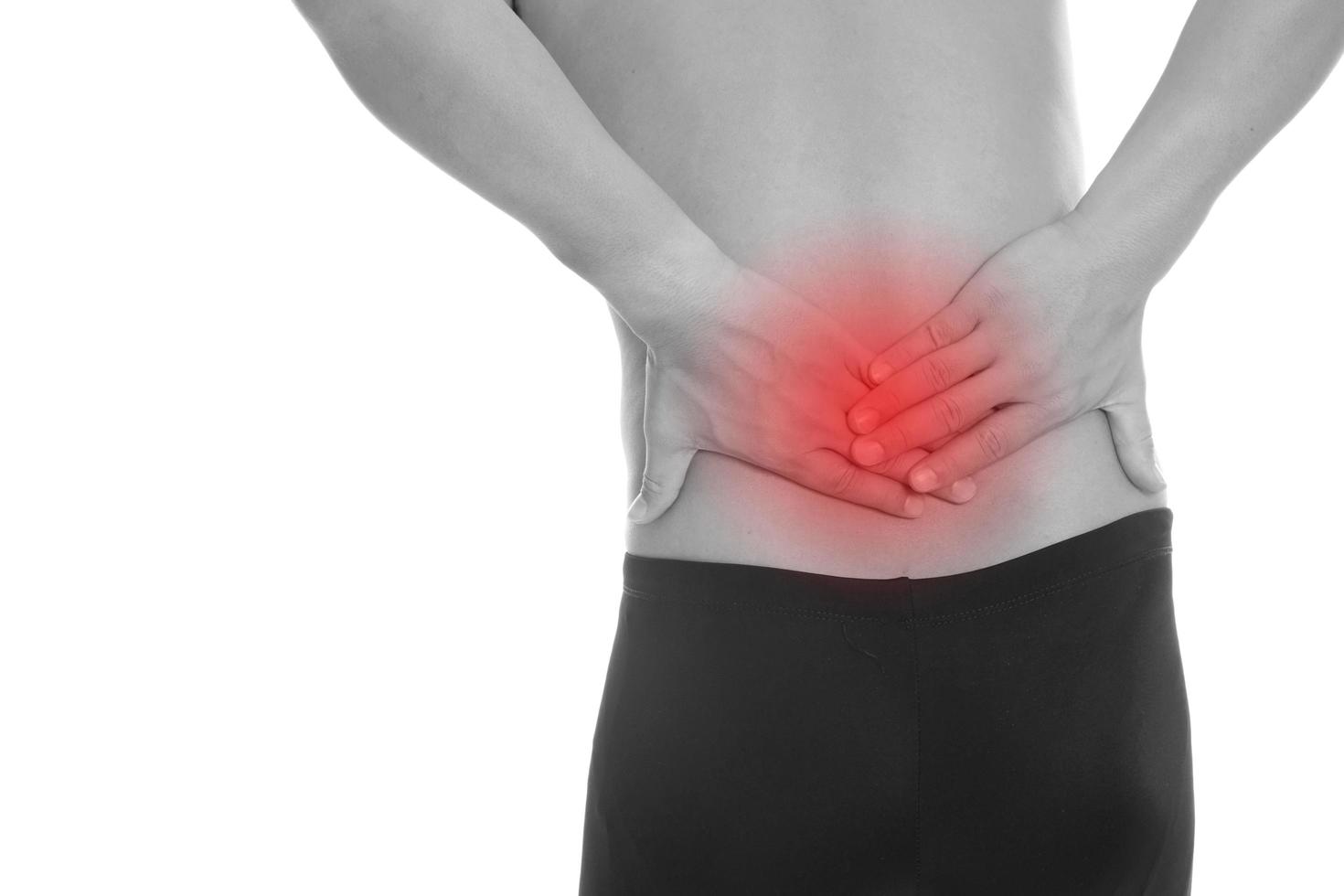 Young man with back pain, isolated on white photo