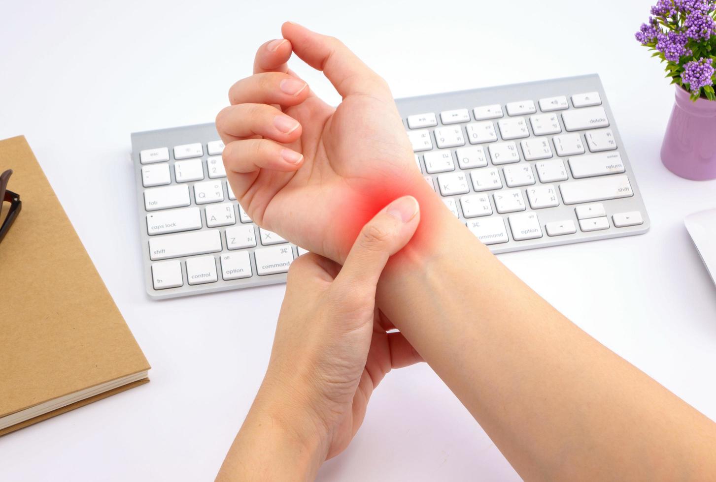 Young woman hand pain with red alert accent photo