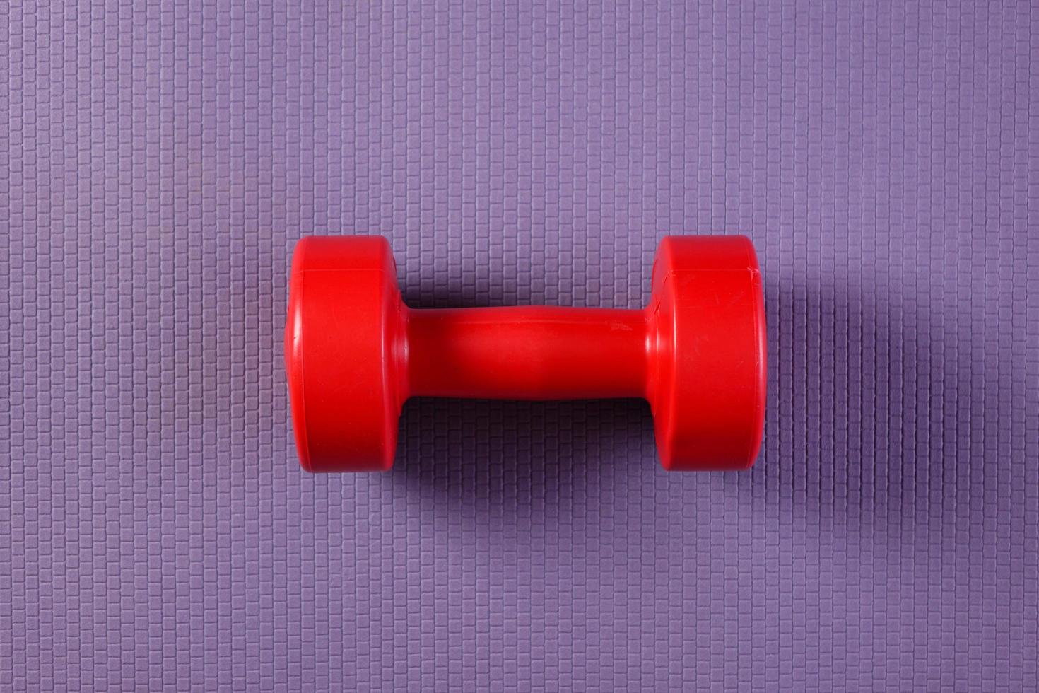 Purple yoga mat with dumbbell photo