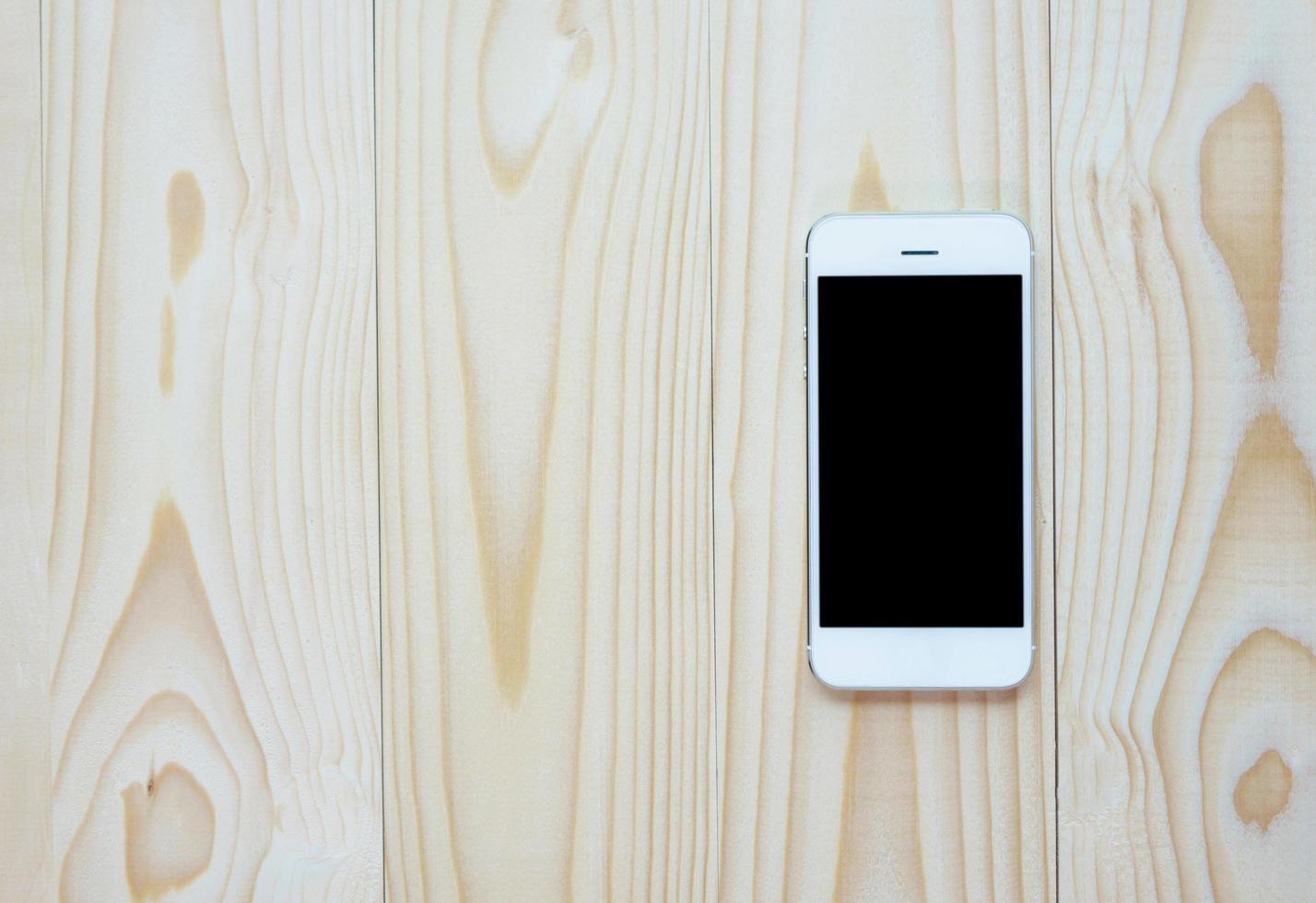 Smart-phone on wooden table photo