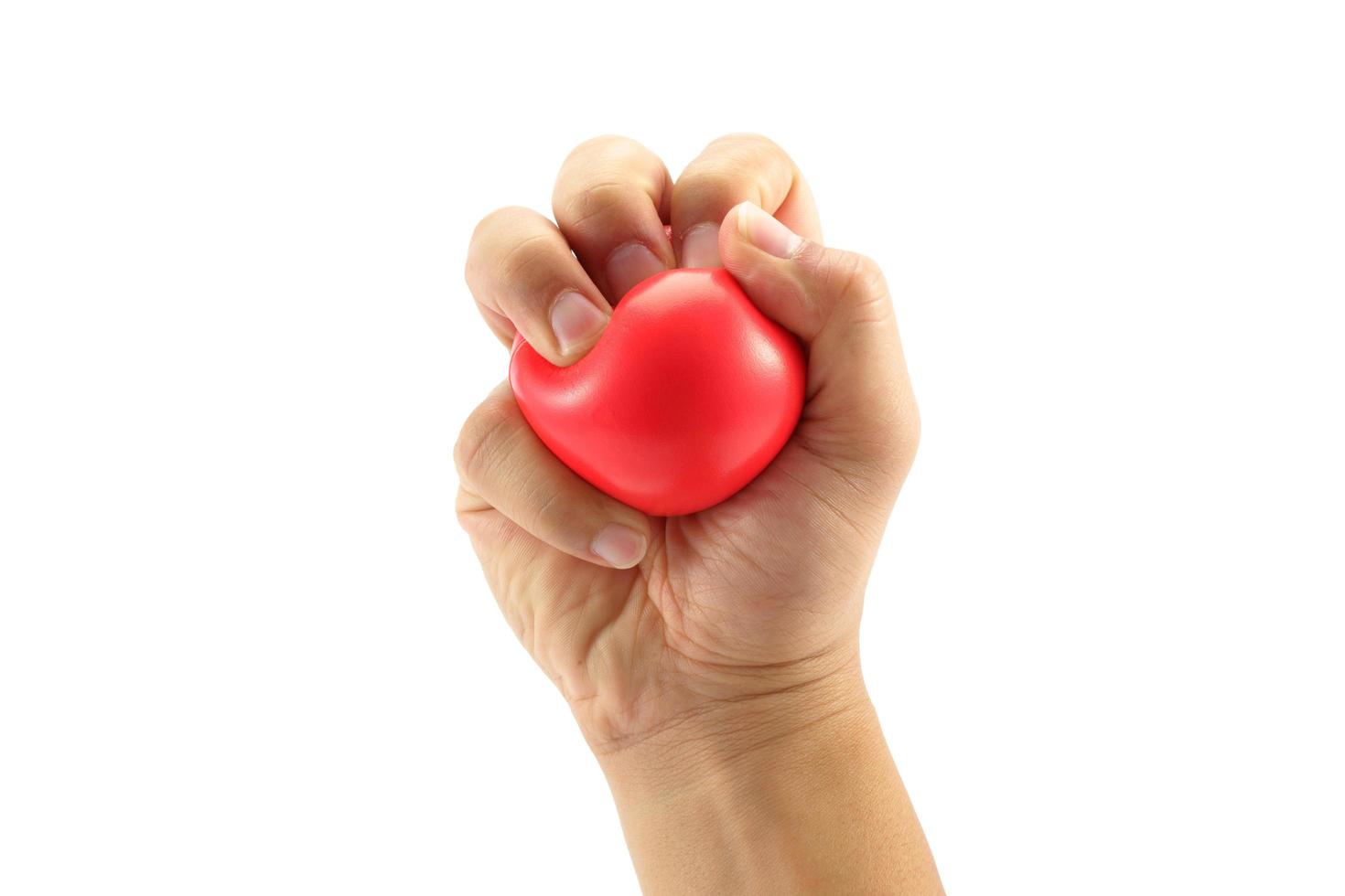 A man hand squeezing a stress ball  on white background photo