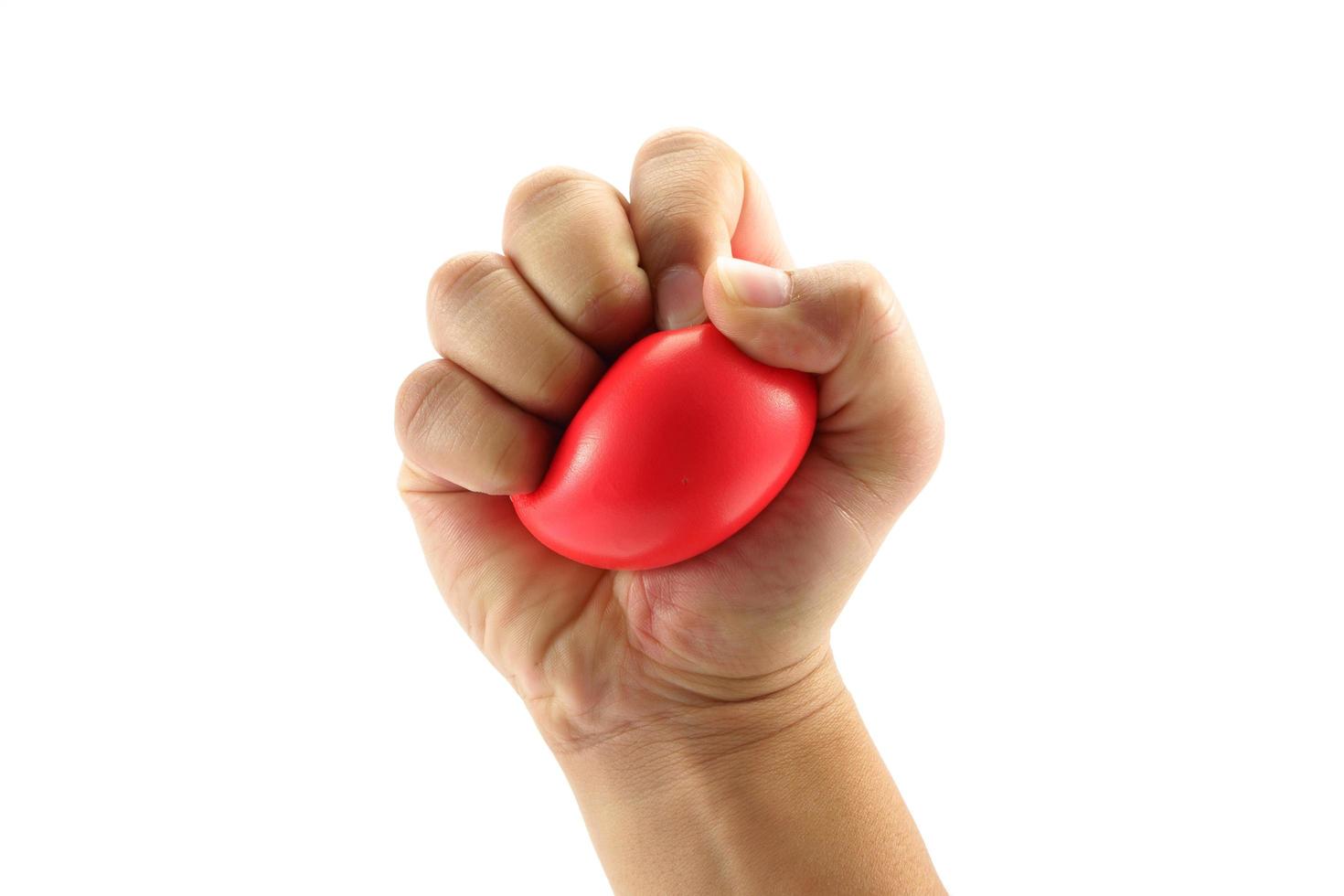 A man hand squeezing a stress ball  on white background photo