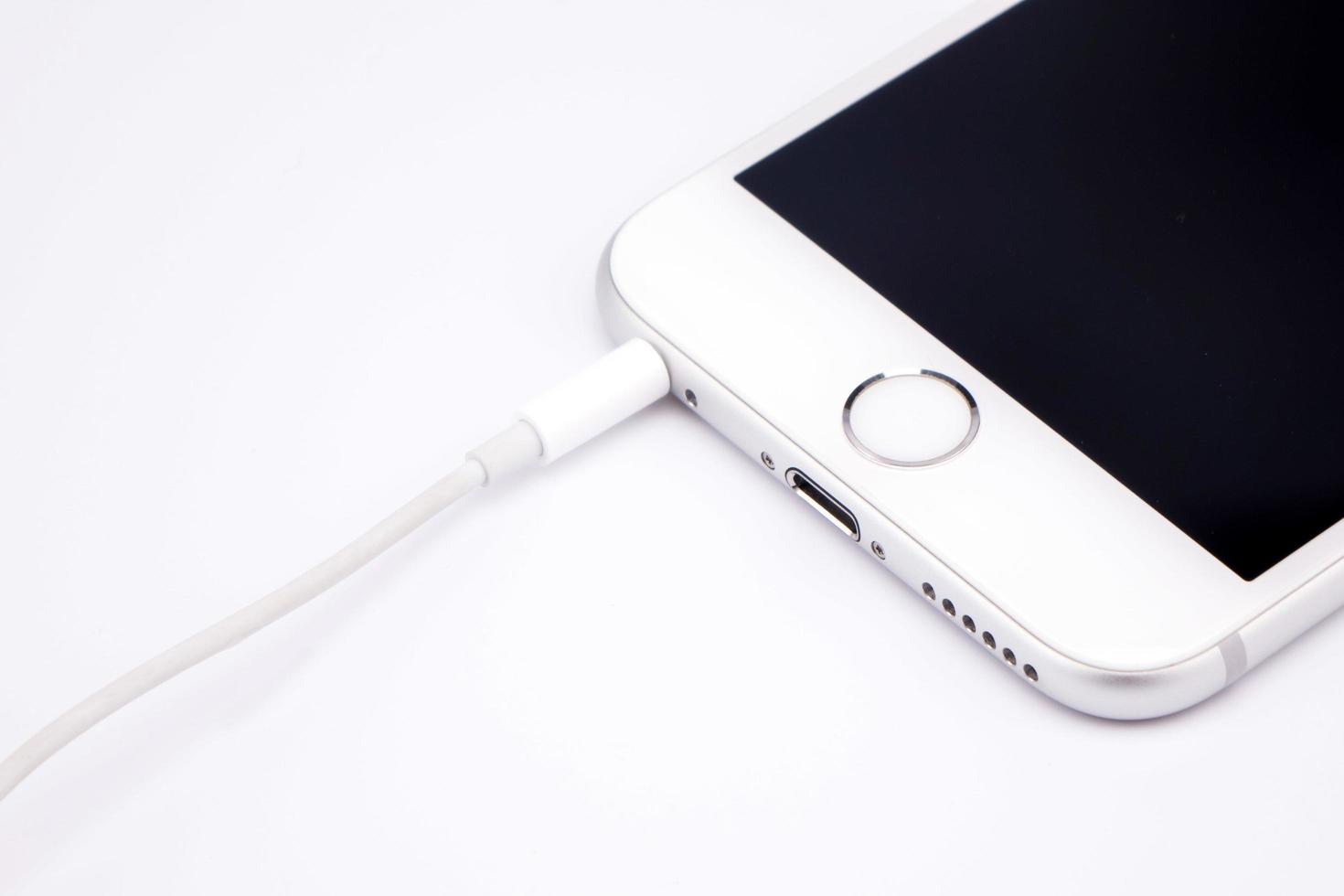 Smart phone  and headphone on white table photo