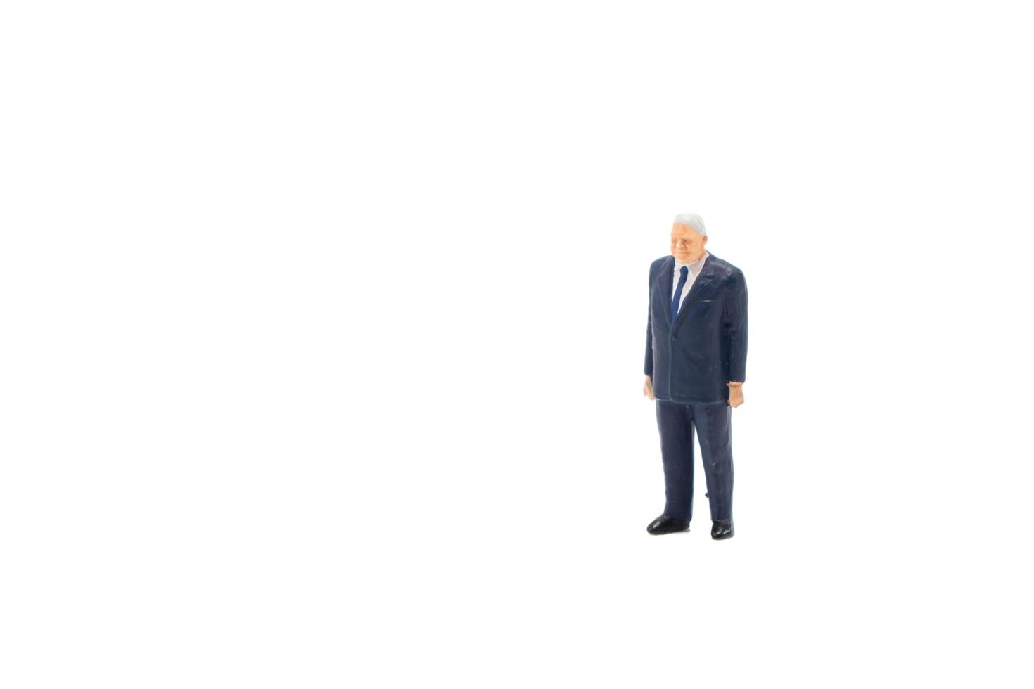 Miniature people businessman on white background photo