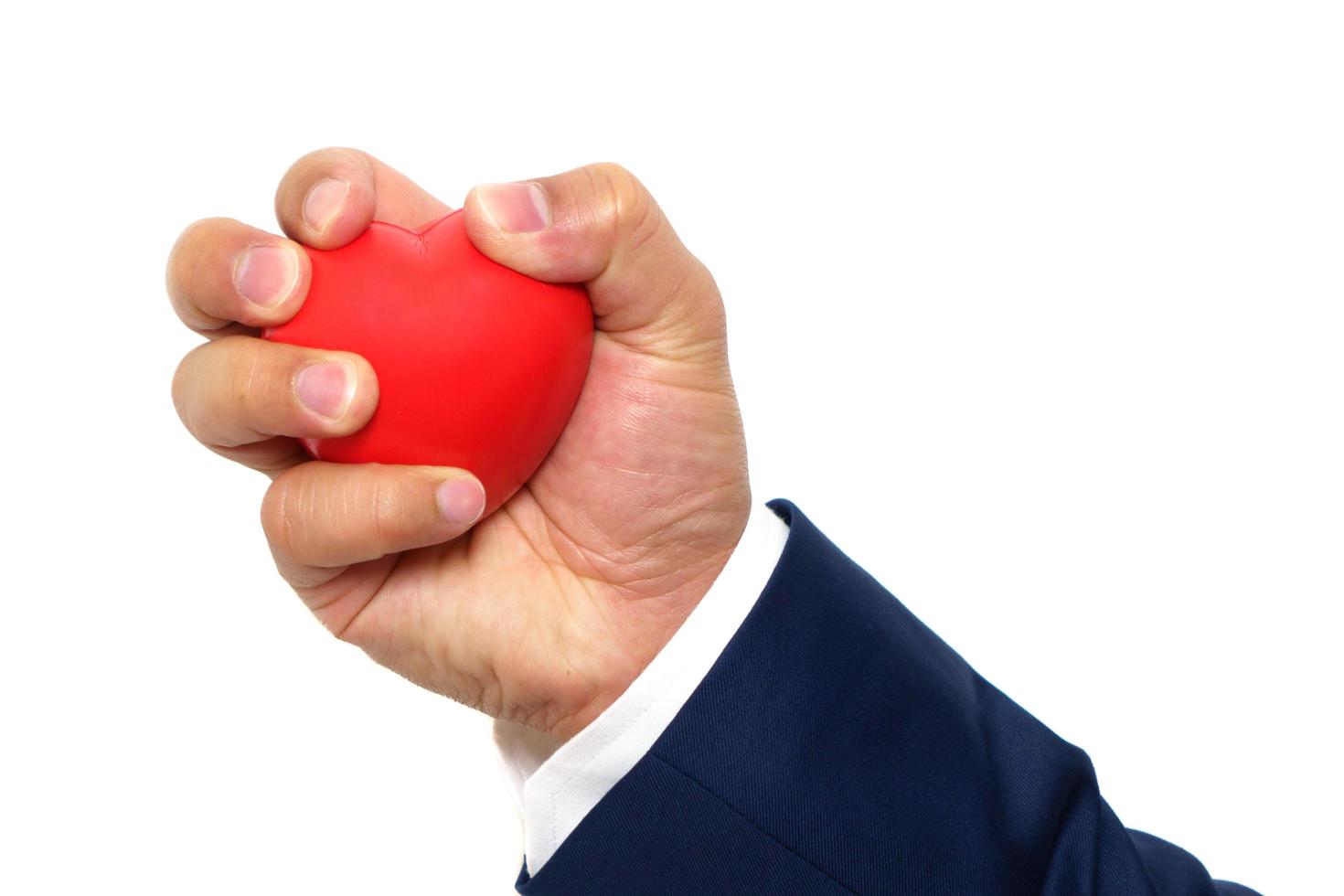 A man hand squeezing a stress ball on white background photo