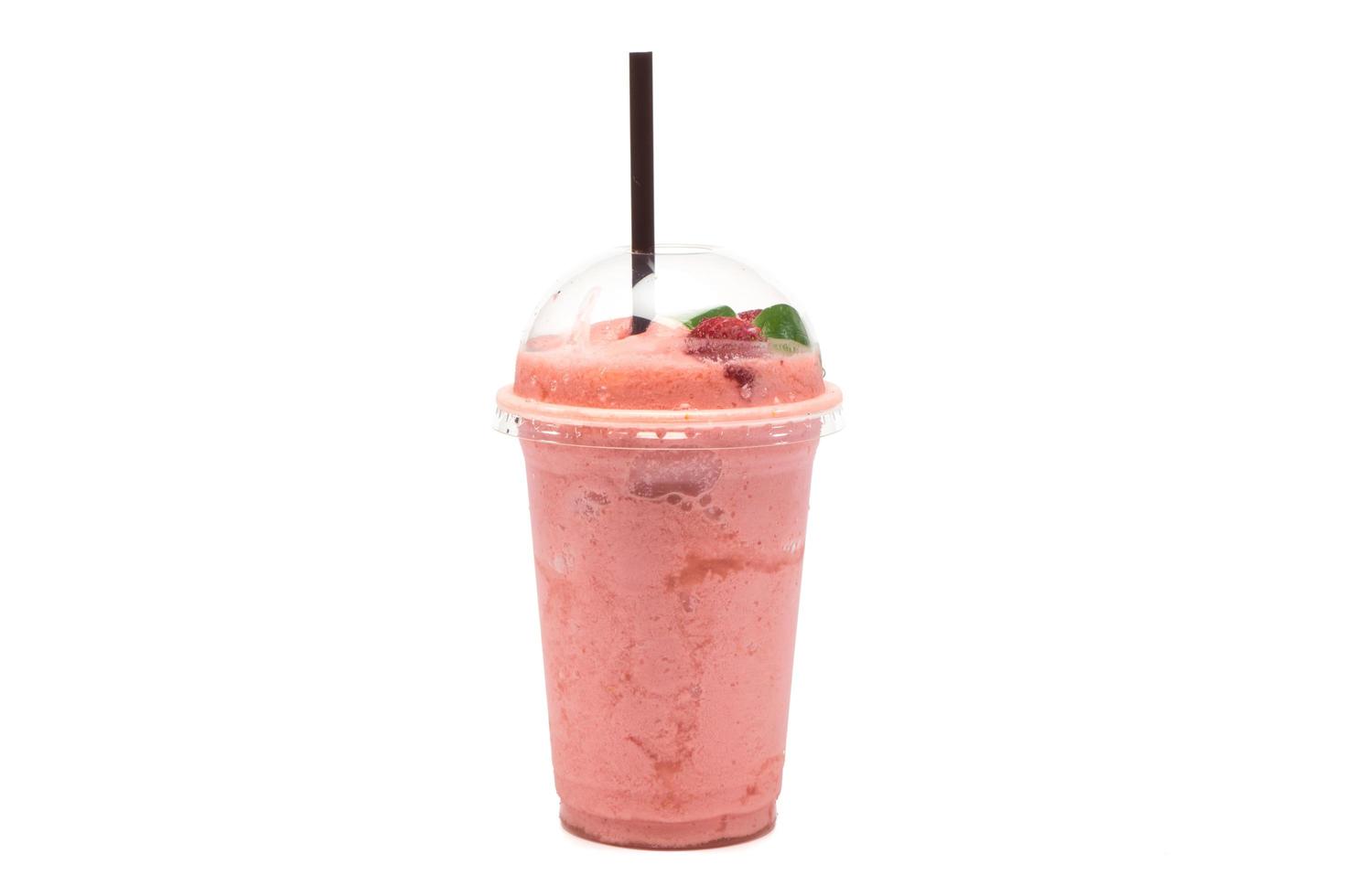 Strawberry smoothie in plastic transparent cup on white background photo