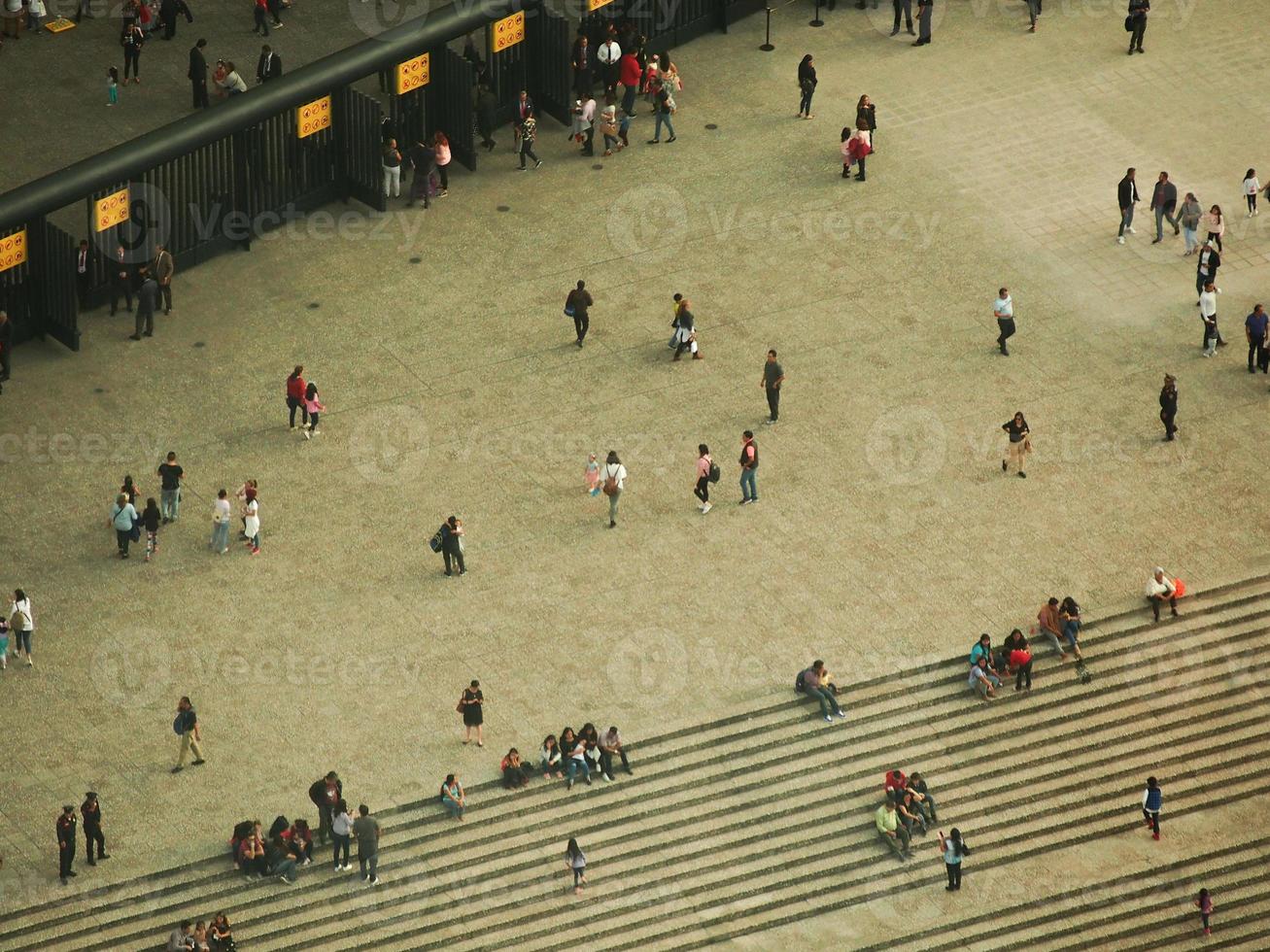 Aerial view of a plaza with people walking and sitting photo