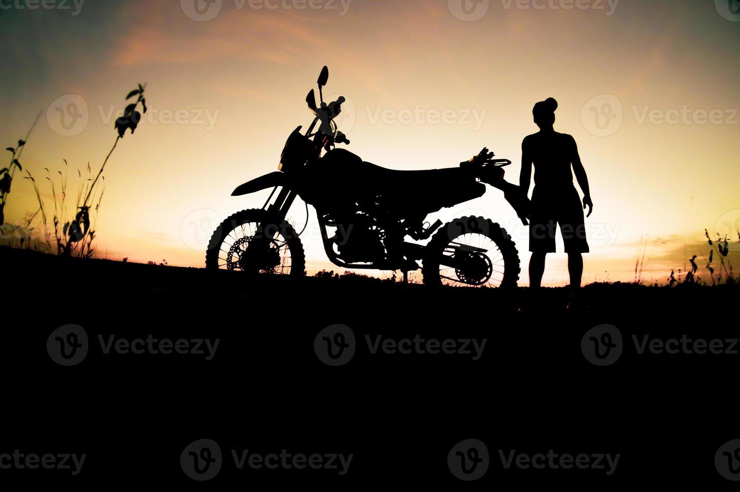 Men's silhouettes and touring motocross bikes. Park to relax in the mountains in the evening. adventure travel and leisure concept photo