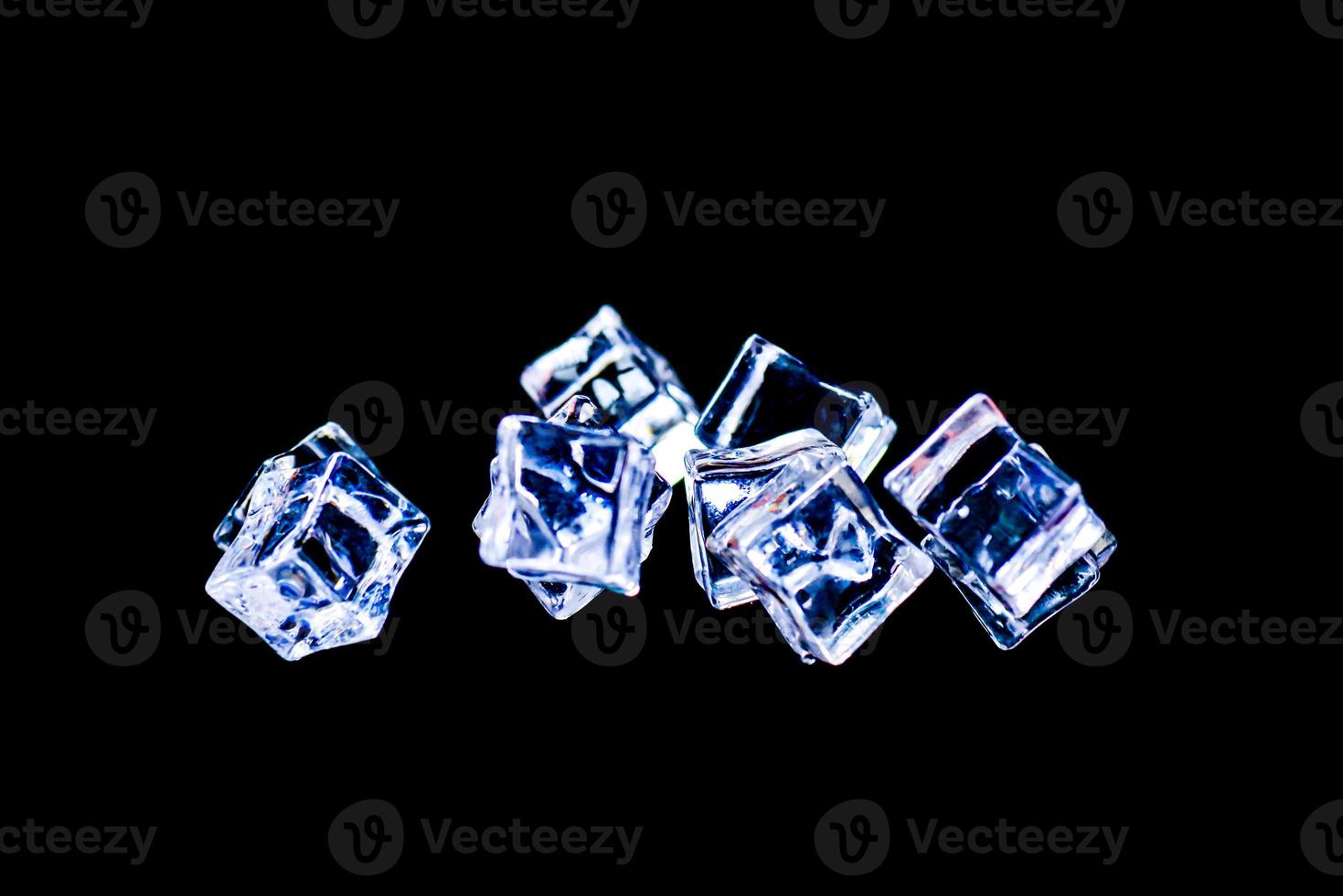 Ice cubes on a black background. ice falling on a black background for use as an illustration in a project photo