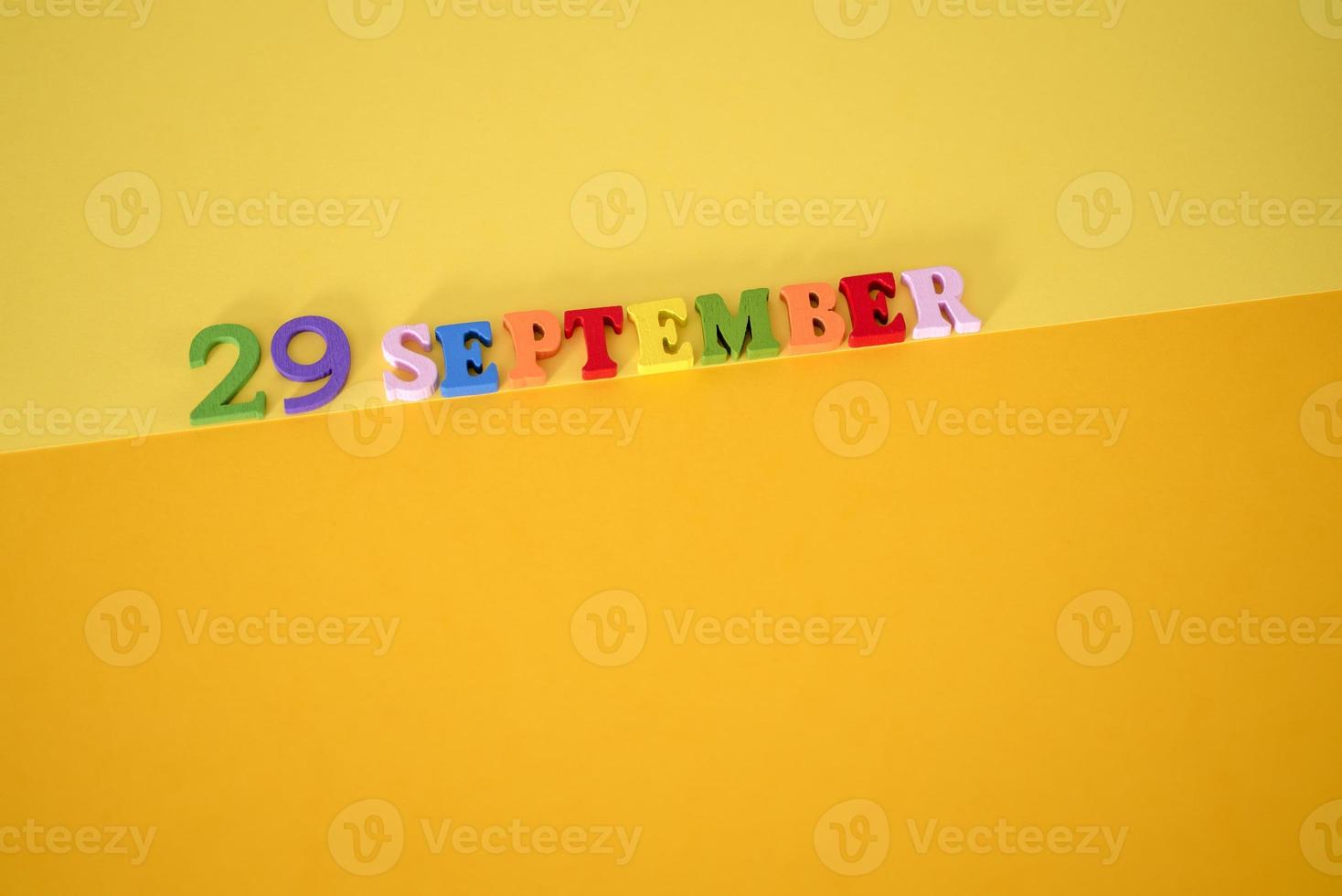 Calendar date of September 29 on yellow, paper background. photo