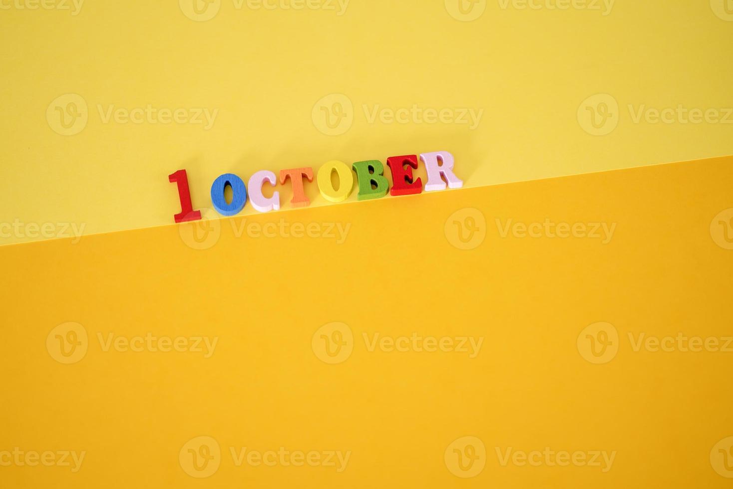 October 1 . First Day, October 1 wooden calendar on yellow abstract background. photo