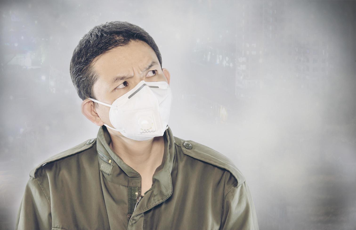 Man wearing mask protect fine dust in air pollution environment - people with protection equipment for air pollution concept photo
