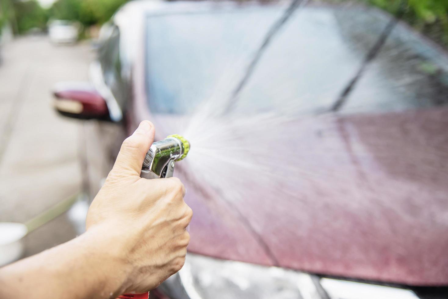 Man wash car using shampoo - every day life car care concept photo