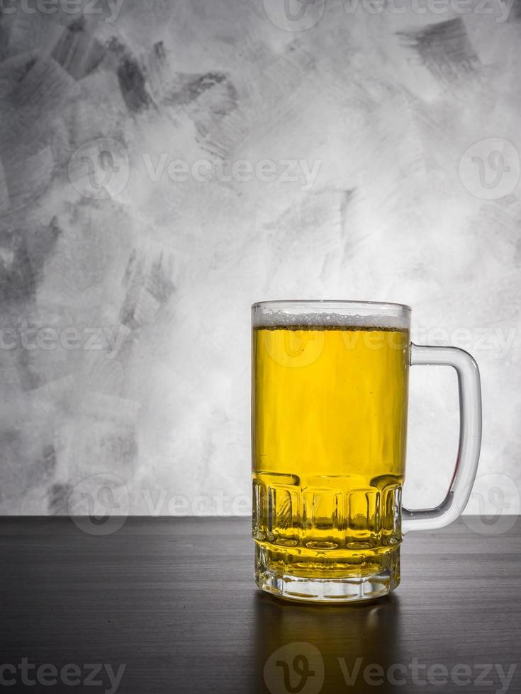 Glass of beer on a grunge background. photo