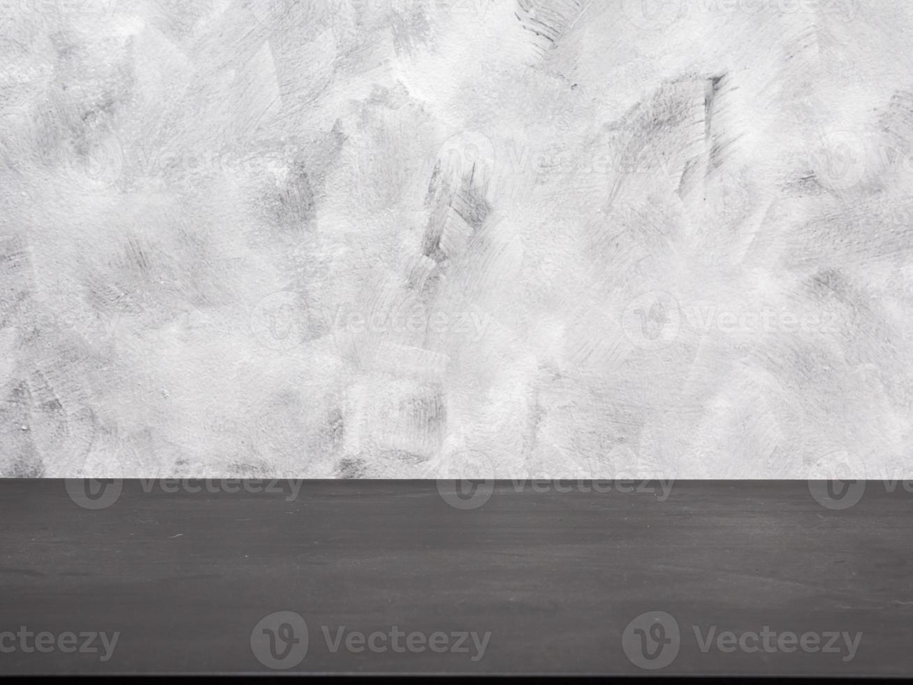 Empty black wooden table on a grunge background. photo