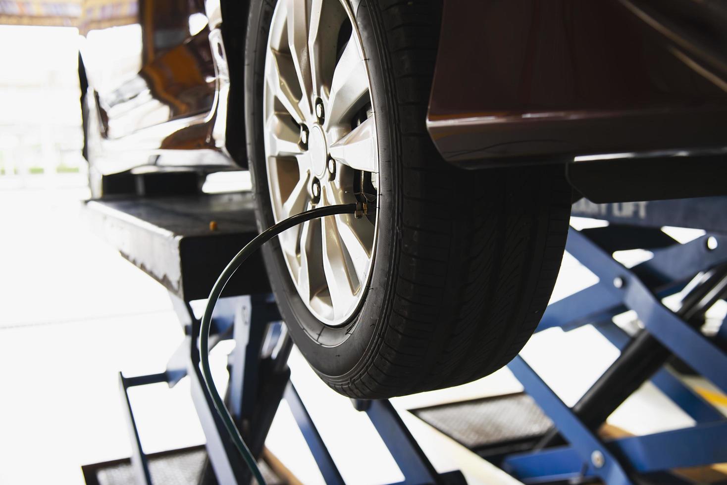 Technician is inflate car tire - car maintenance service transportation safety concept photo