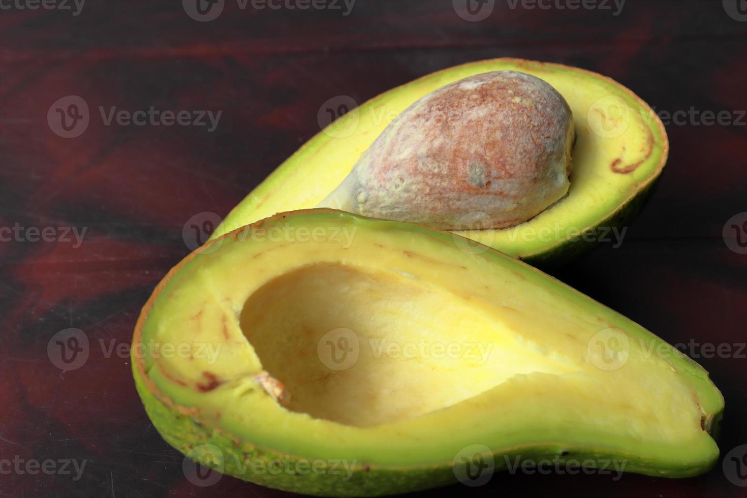 Fresh tropical avacado fruit over dark background photo