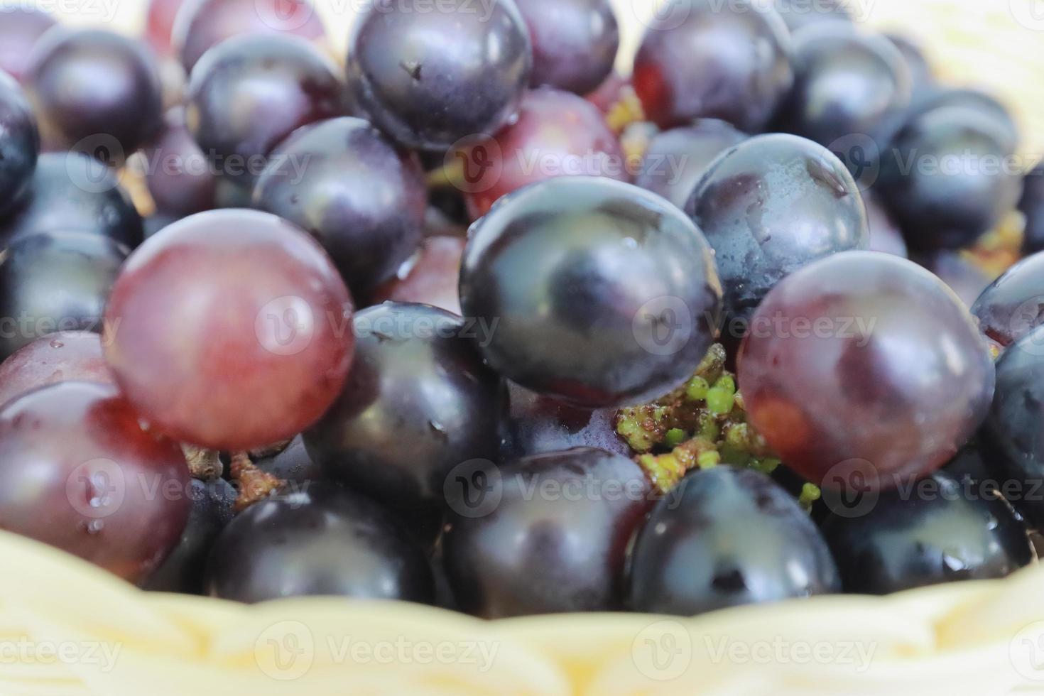Ripe purple grapes on a nice wicker pot. Fresh Healthy Fruits photo