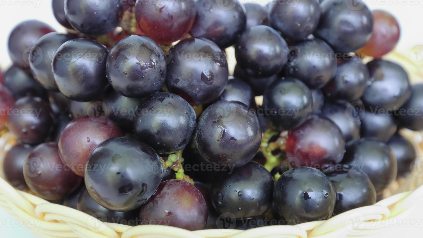 Ripe purple grapes on a nice wicker pot. Fresh Healthy Fruits photo