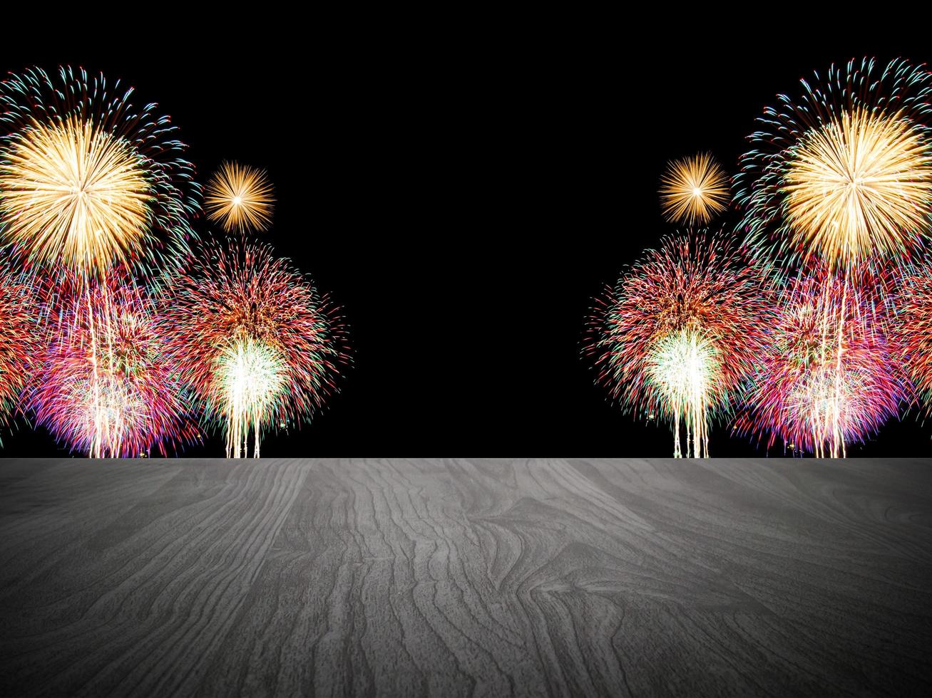 Empty wooden table in front of fireworks background. photo