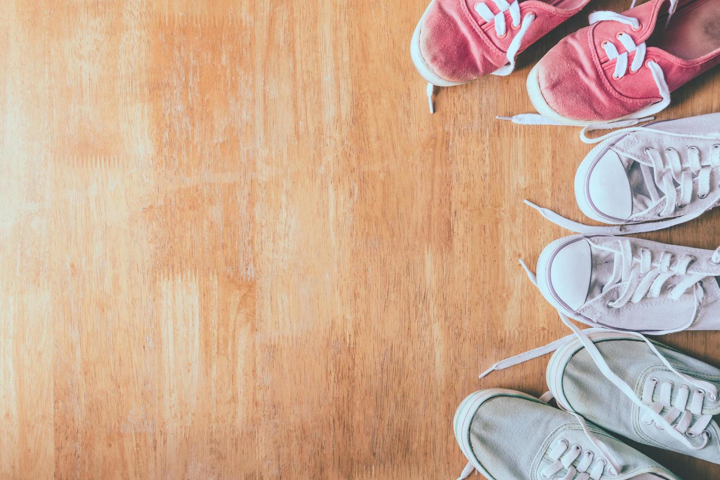 Top view of Colorful sneakers on the wooden table background. photo