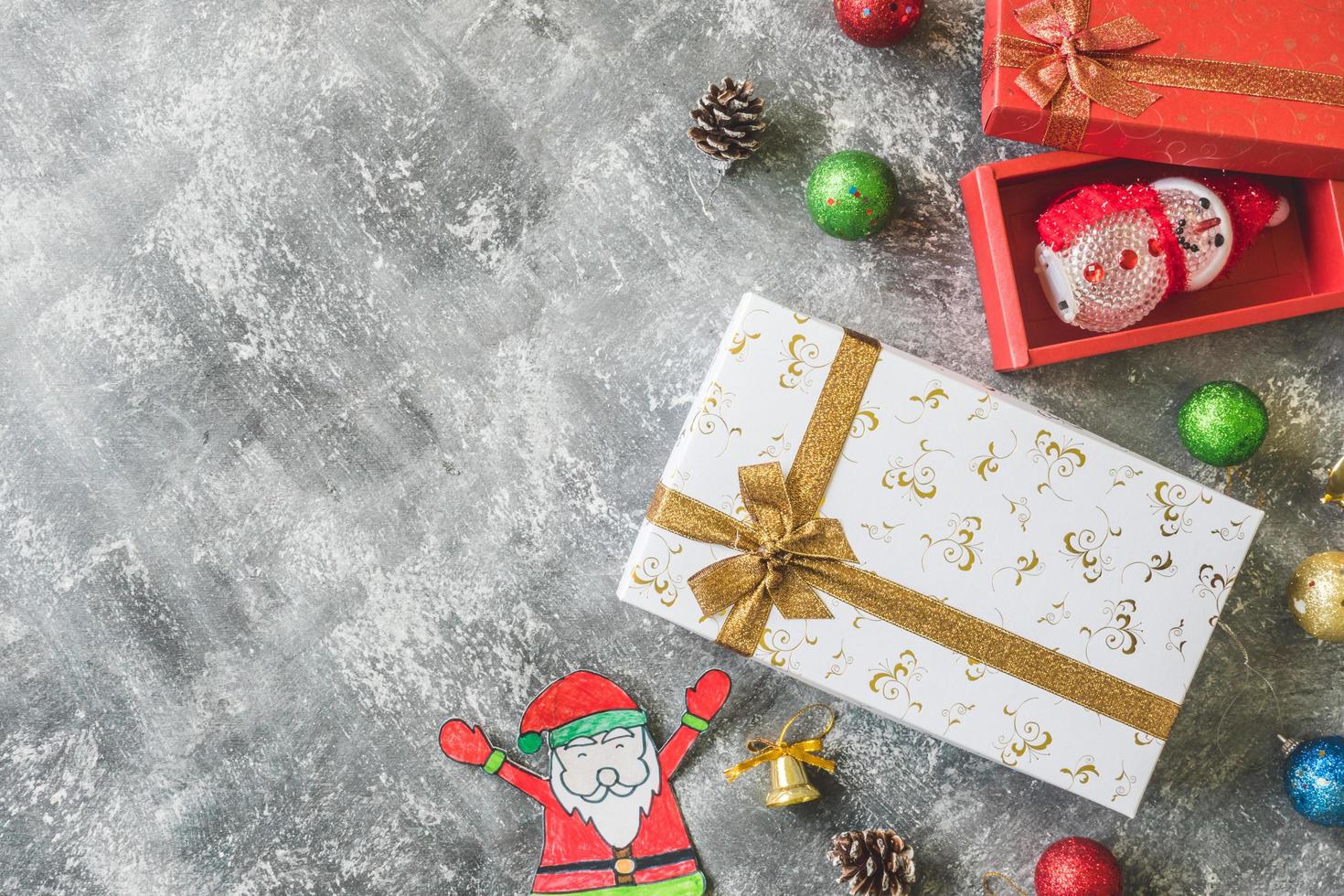 Top view of Gift boxes with Christmas decoration on gray grunge background. photo