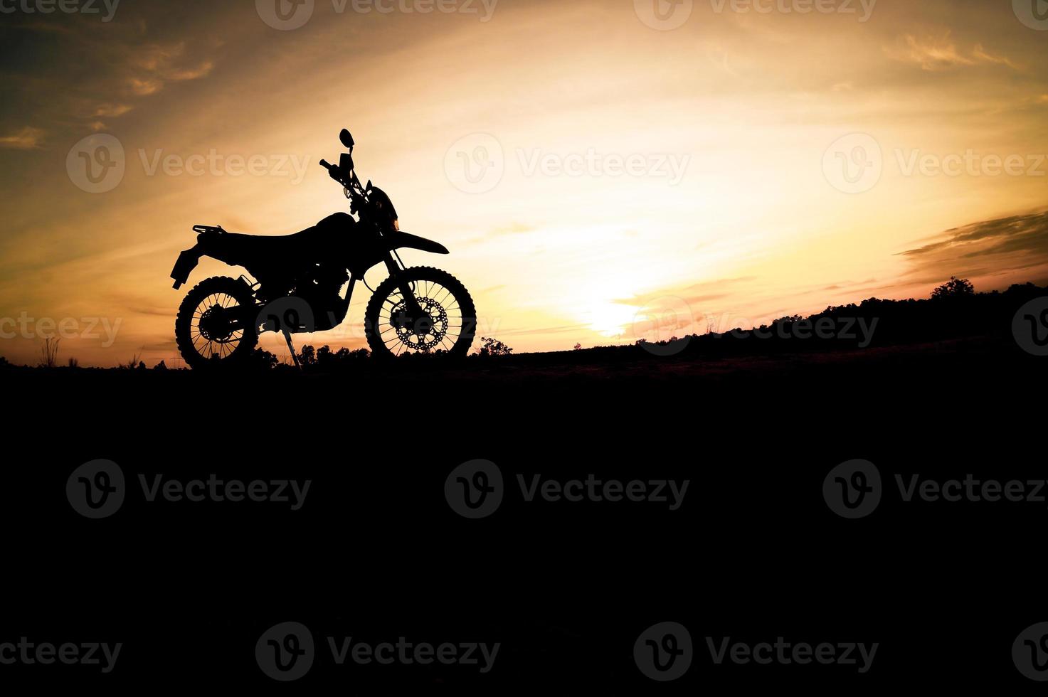 Tourist motorcycle motocross silhouette Park on the mountain in the evening. adventure travel concept photo