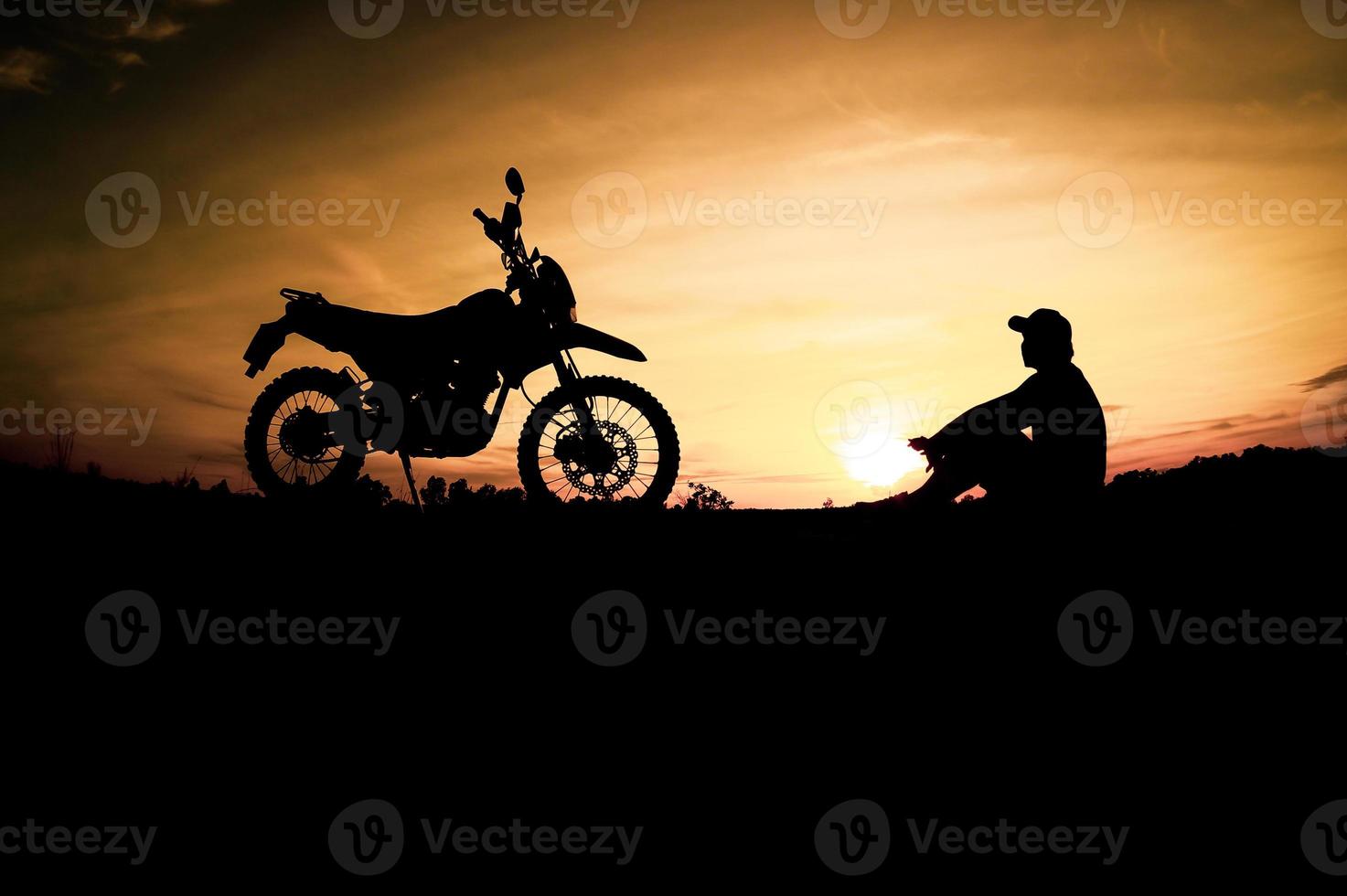 Men's silhouettes and touring motocross bikes. Park to relax in the mountains in the evening. adventure travel and leisure concept photo