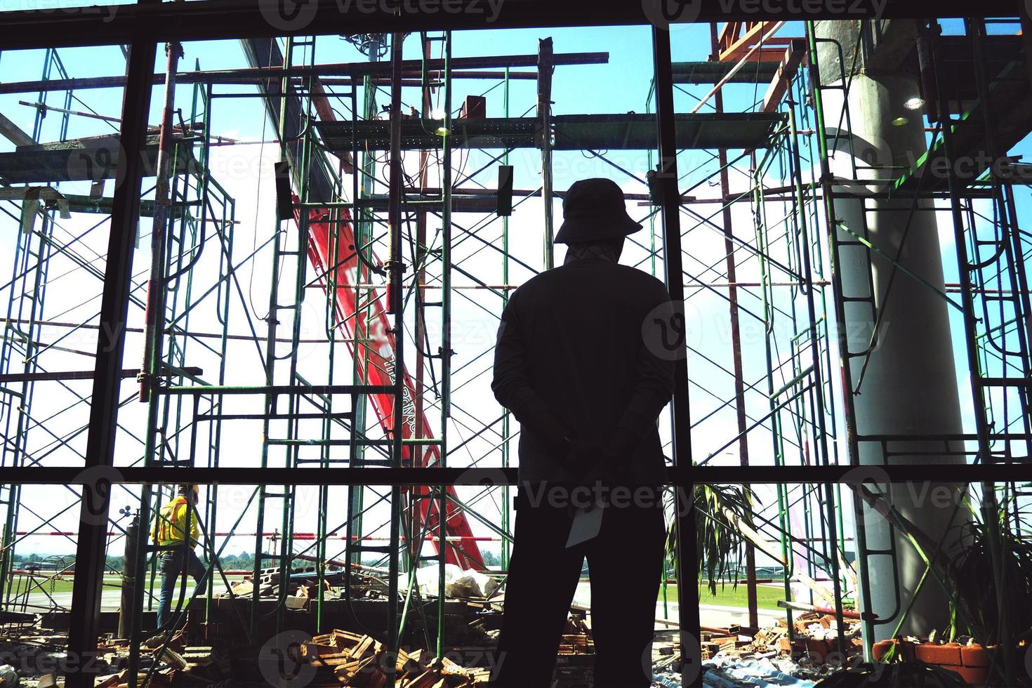 Worker man standing at the construction site photo