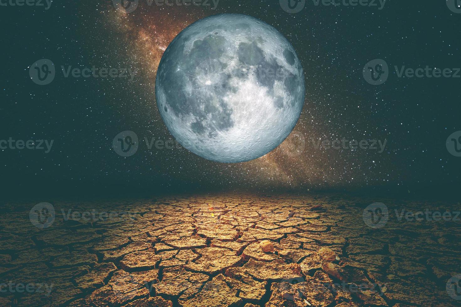 A drought-stricken area due to global warming, with the moon and stars at night. photo