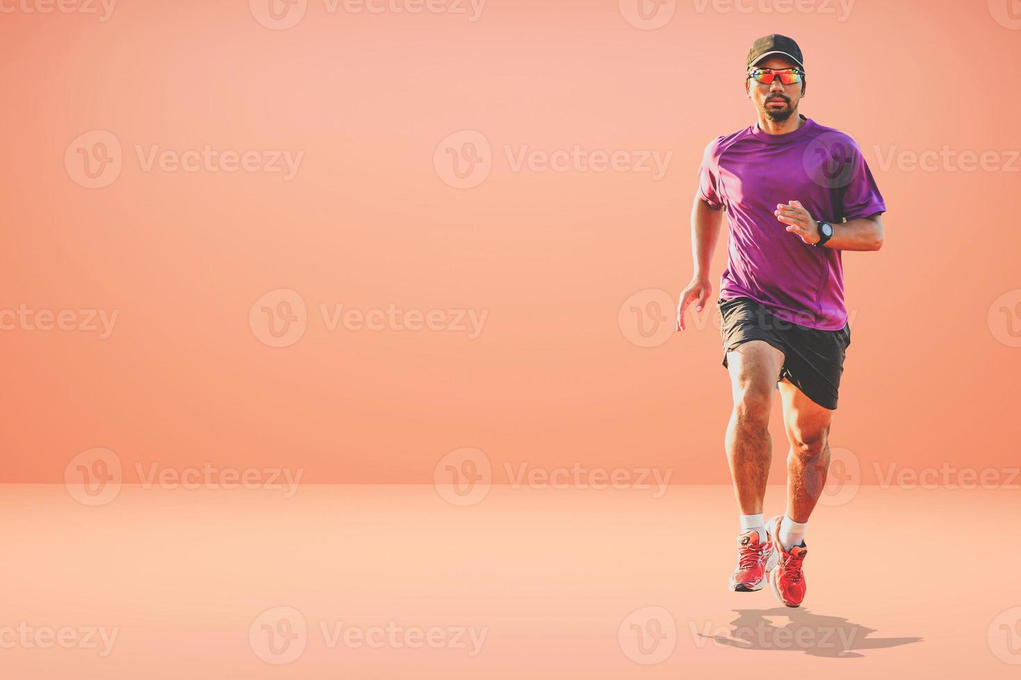 Healthy Asian man running on colored background with copyspace. photo