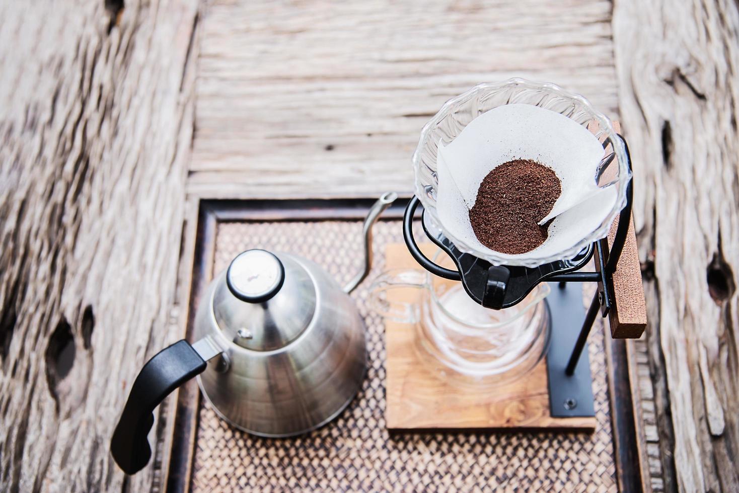 Making drip coffee in vintage coffee shop with green garden nature background - fresh coffee in nature concept photo