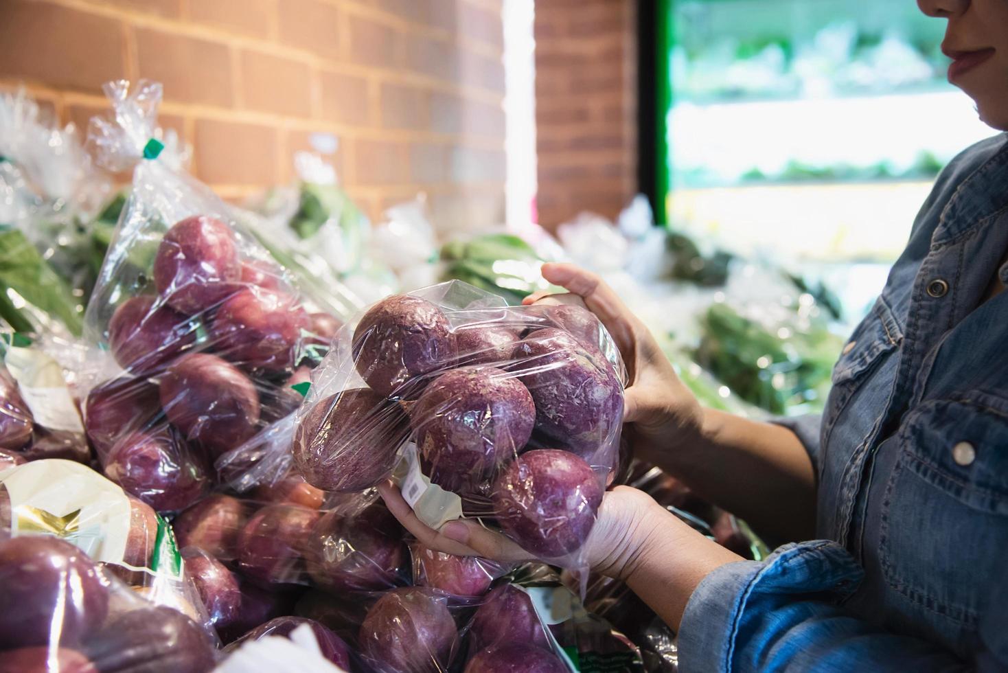 Lady is shopping fresh vegetable in supermarket store - woman in fresh market lifestyle concept photo