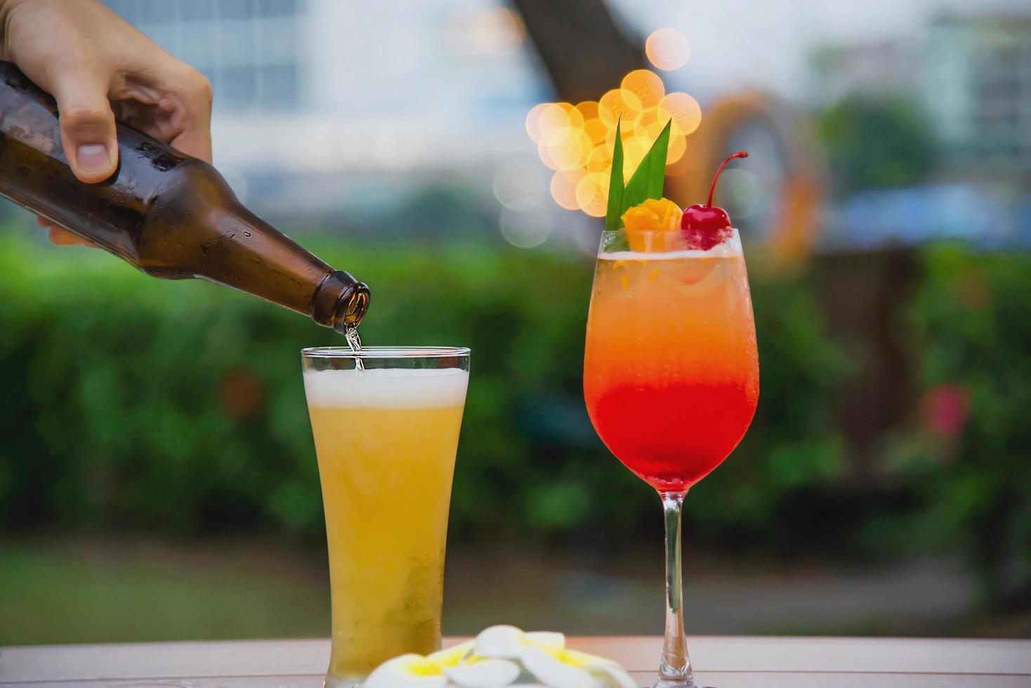 People celebration in restaurant with beer and mai tai or mai thai - happy lifestyle people with happy drink in garden concept photo