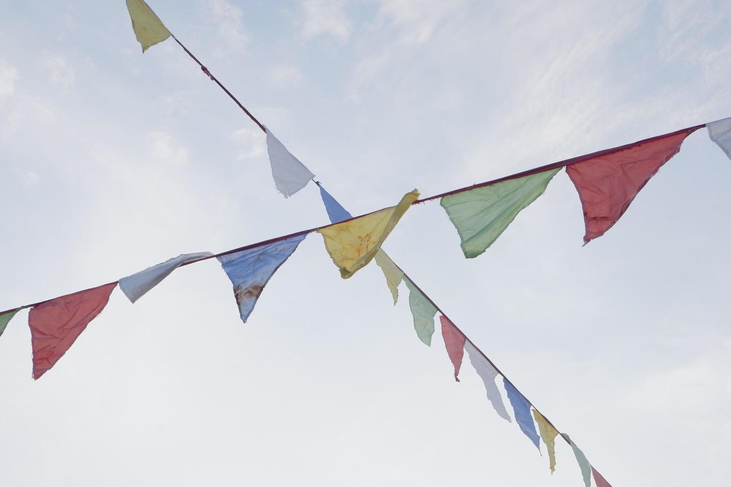 Festive colorful flags in the blue sky photo