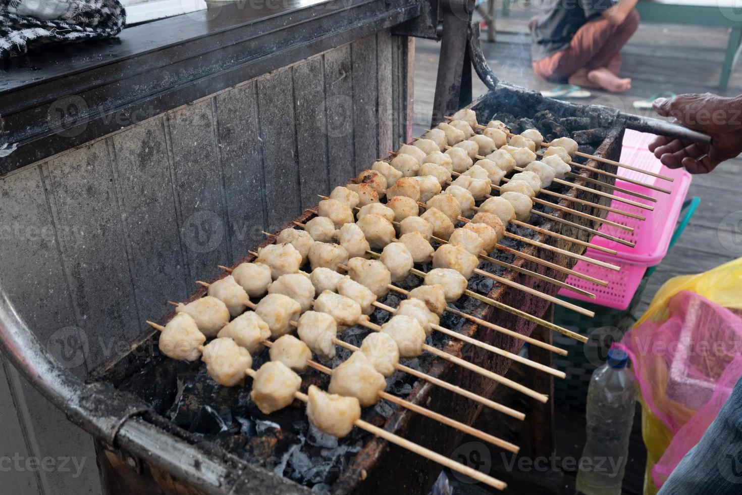 selective focus on grilled meatballs skewered with bamboo and sold at culinary festivals photo
