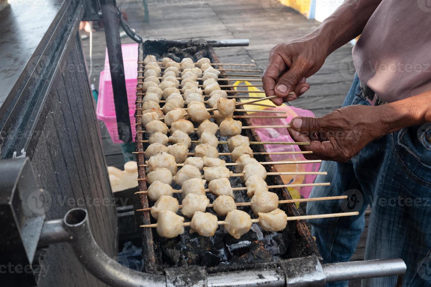 selective focus on grilled meatballs skewered with bamboo and sold at culinary festivals photo