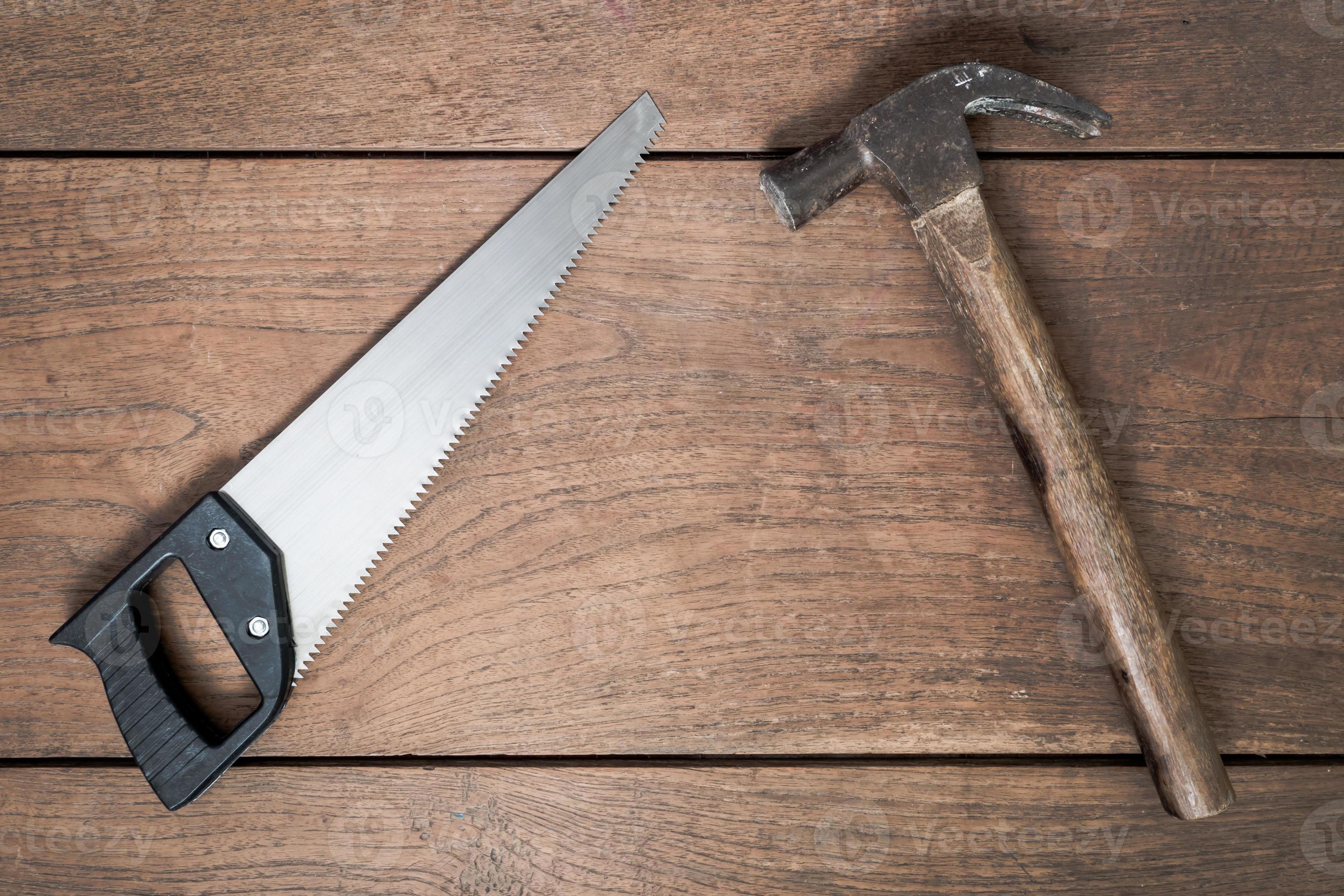 hammer and saw on wooden table background. 10104192 Stock Photo at Vecteezy