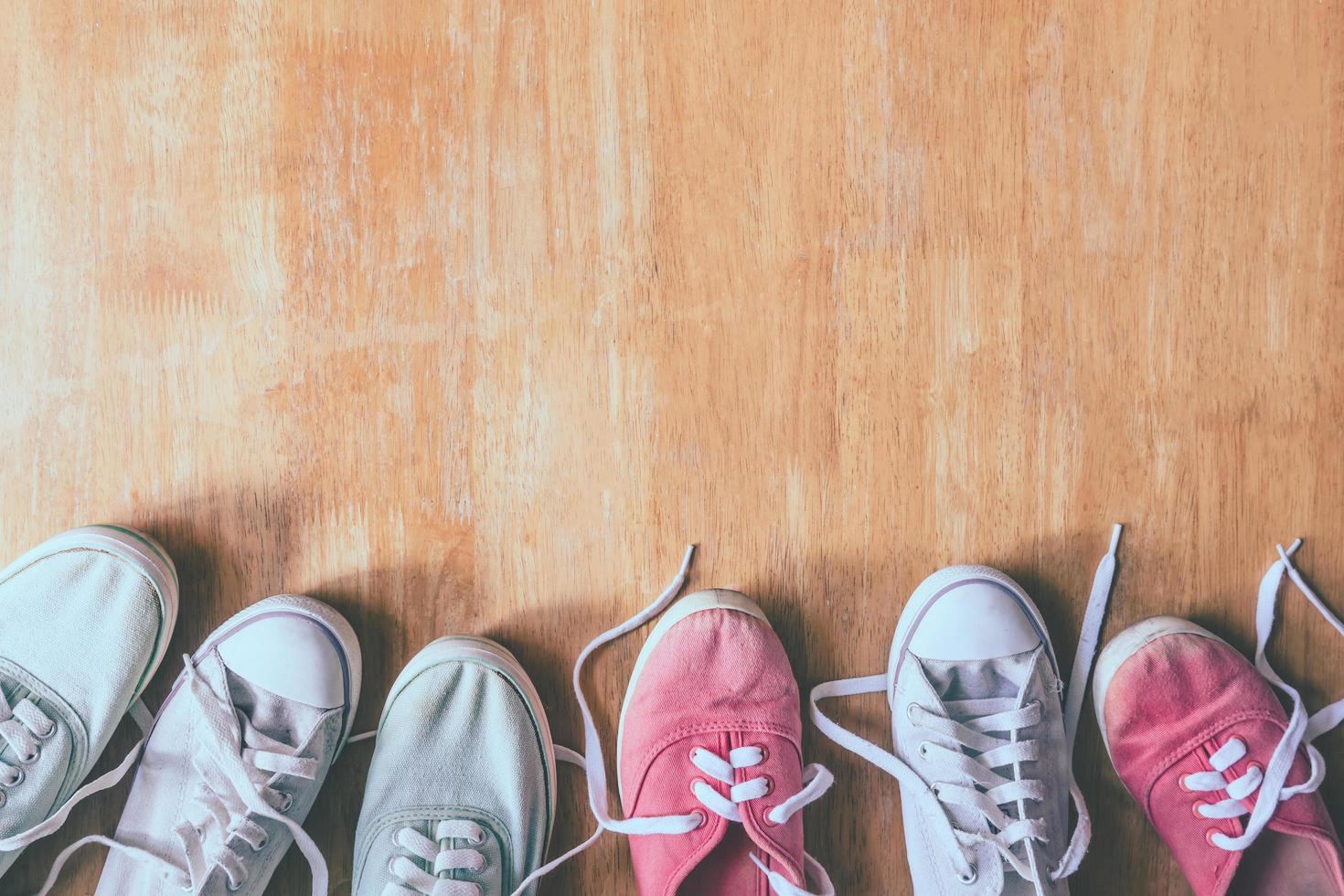 Top view of Colorful sneakers on the wooden table background. photo