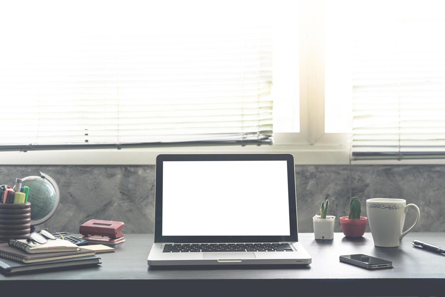 Laptop with white screen on the office desk. photo