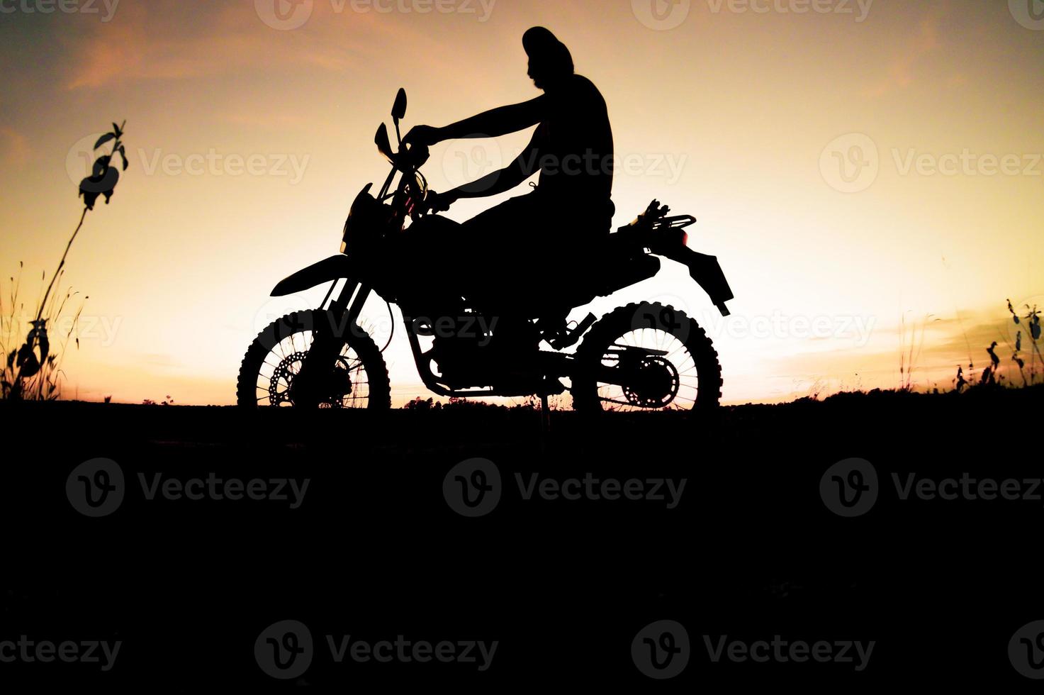 Men's silhouettes and touring motocross bikes. Park to relax in the mountains in the evening. adventure travel and leisure concept photo