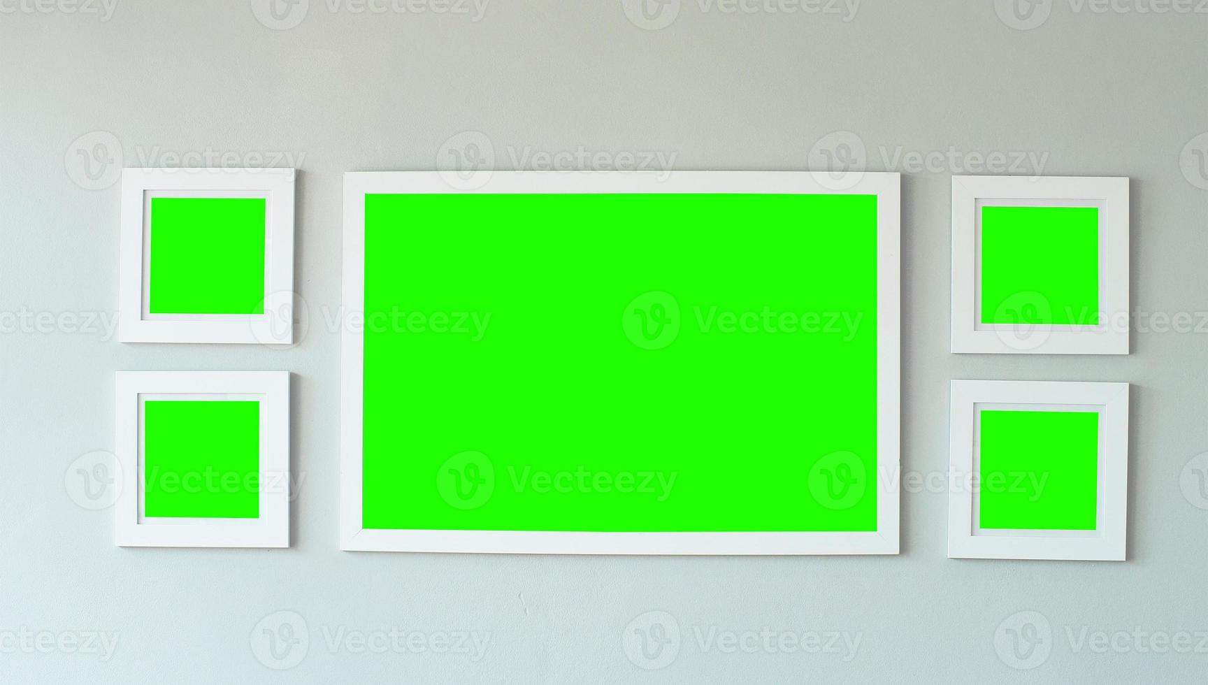 White picture frame on concrete wall with copyspace for inserting desired content. photo