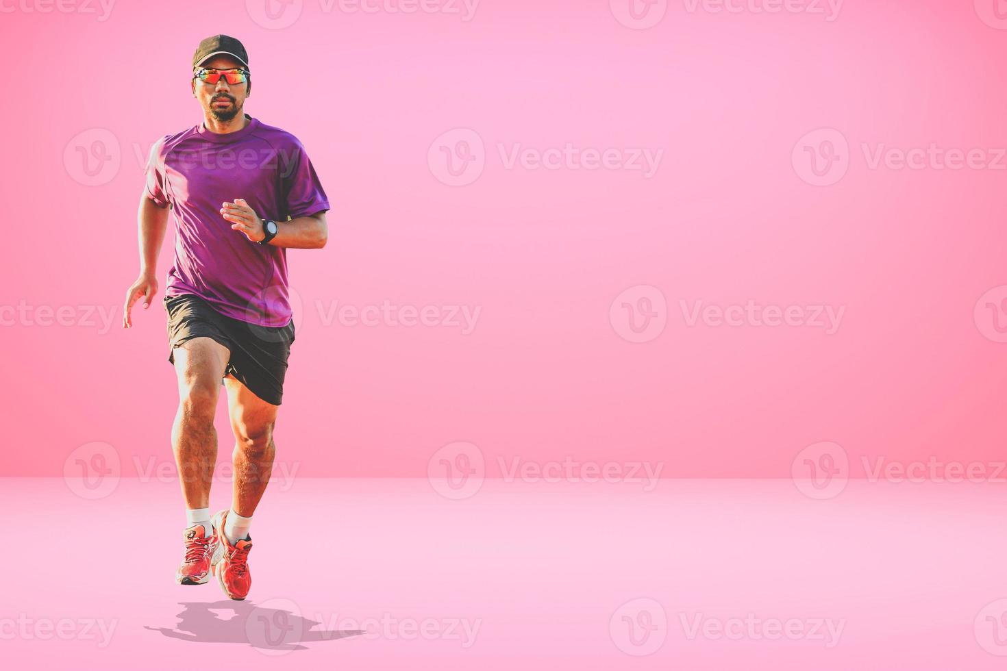 Healthy Asian man running on colored background with copyspace. photo