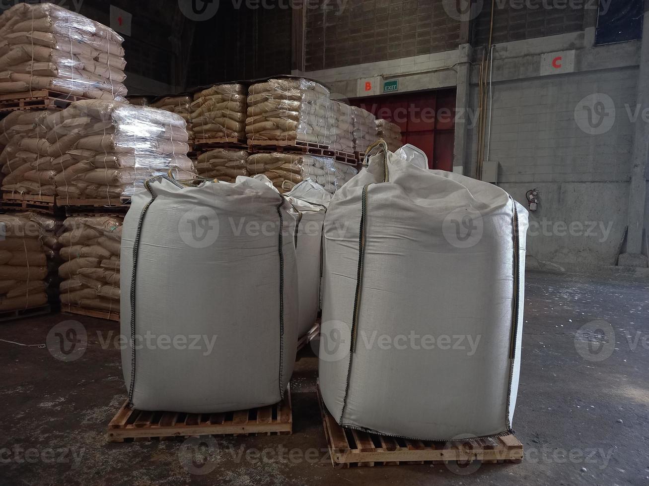 Large jumbo hemp sack White, packed with chemical fertilizer, rice, sugar, placed on a wooden pallet waiting to be delivered to the customer photo