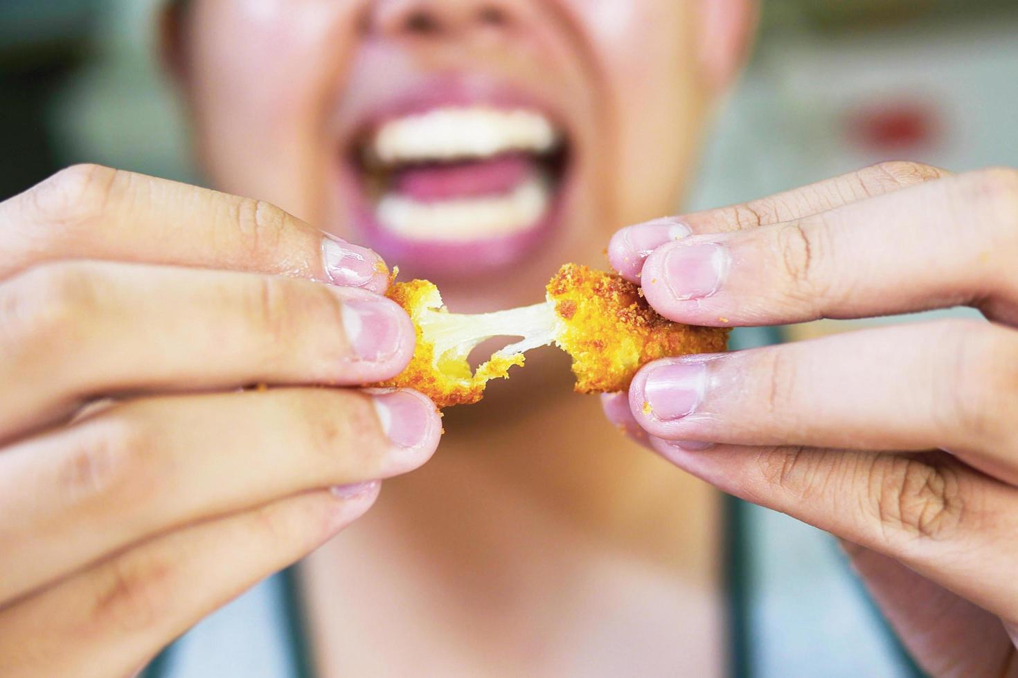 Man is going to eat sticky stretch fried cheese photo