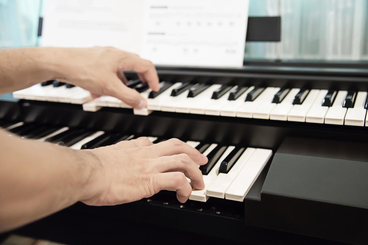 Man hand play electone keyboard - people with music concept photo