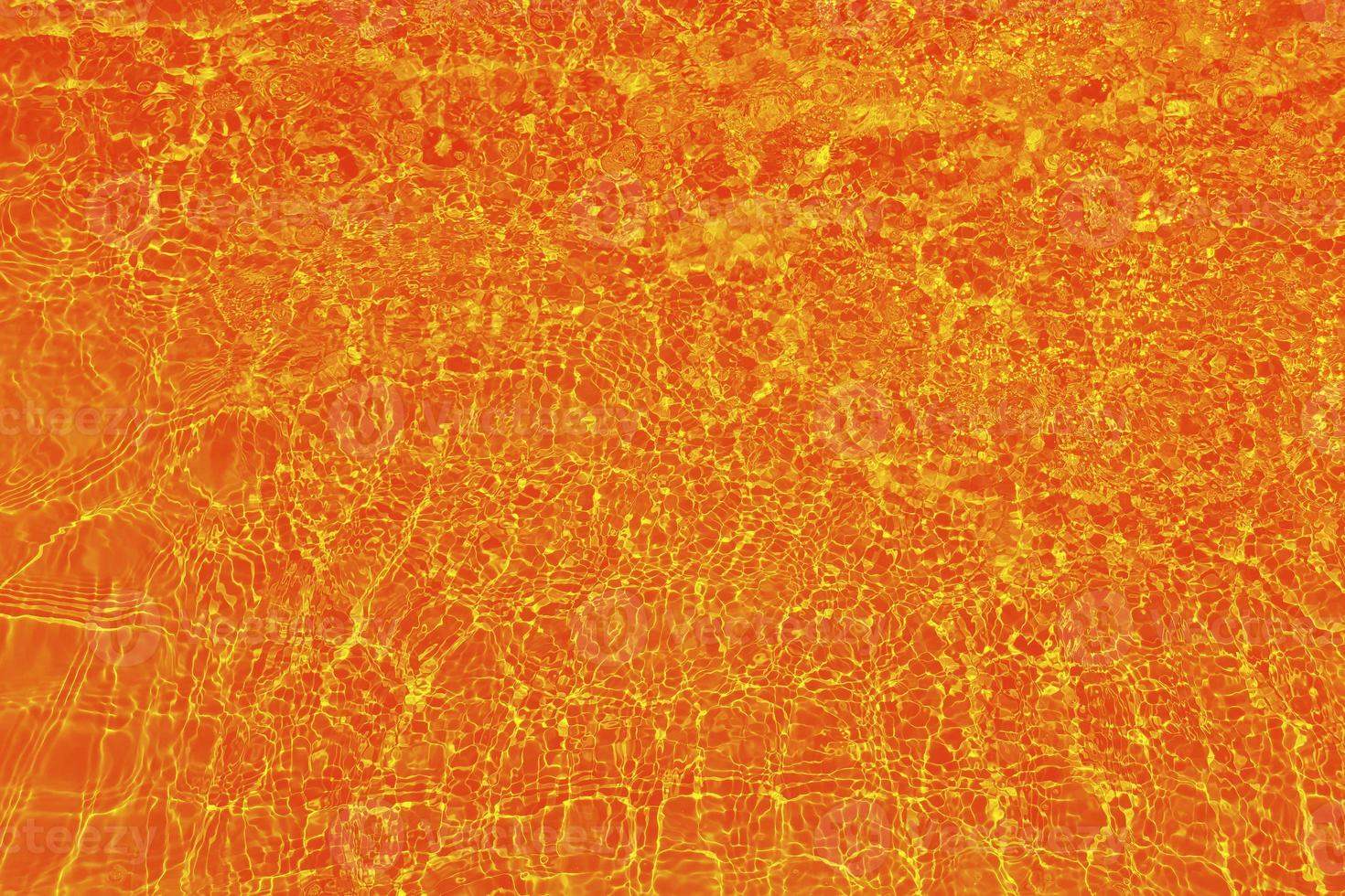 Defocus blurred orange water shining in the sea. rippled water detail background. The water surface in the sea, ocean background. Water wave under sea texture background. photo